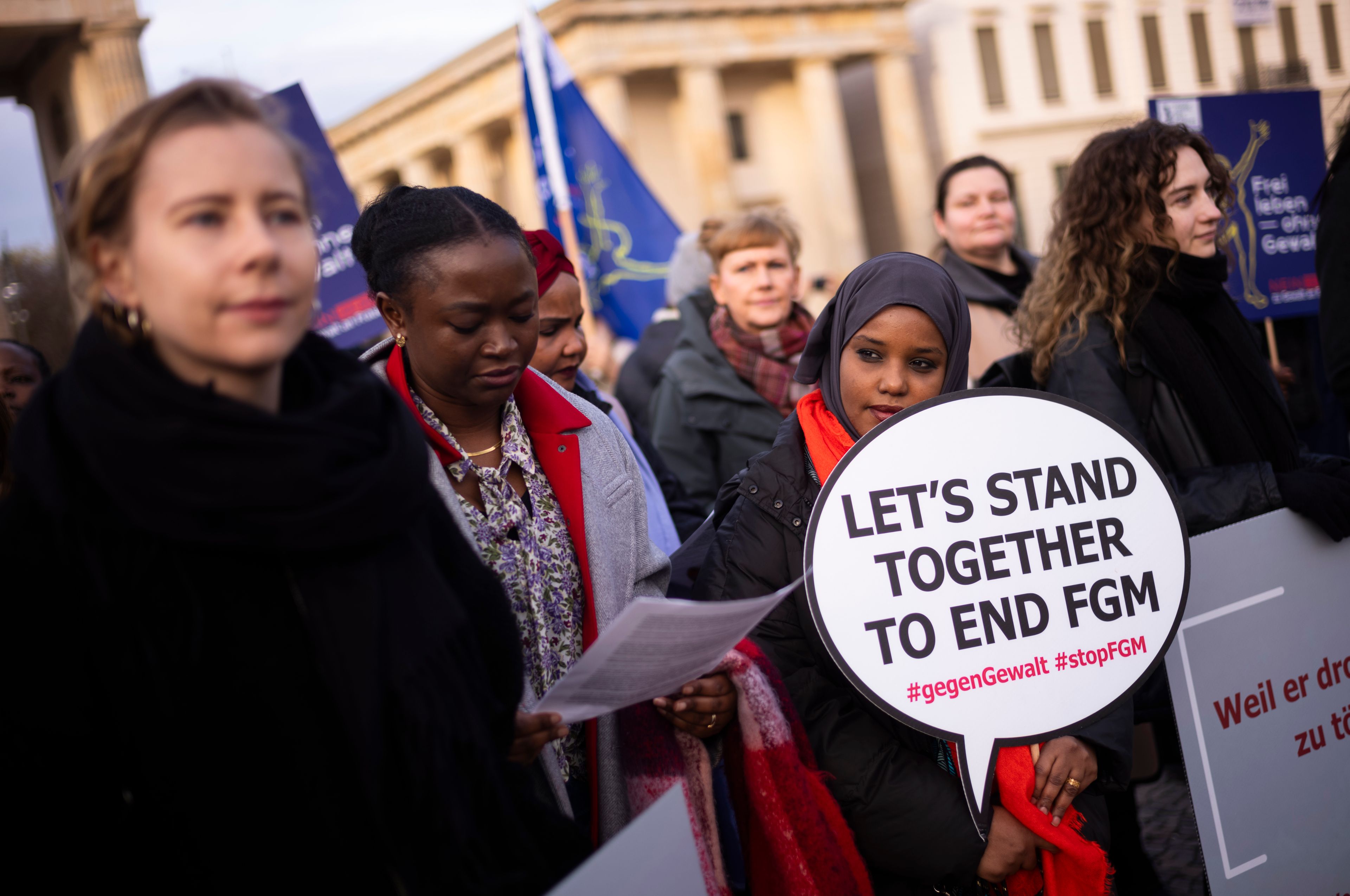 Women attend a protest of the Terre des Femmes human rights organisation to mark the International Day for the Elimination of Violence Against Women in front of the Brandenburg Gate in Berlin, Germany, Monday, Nov. 25, 2024. FGM stands Female genital mutilation. (AP Photo/Markus Schreiber)