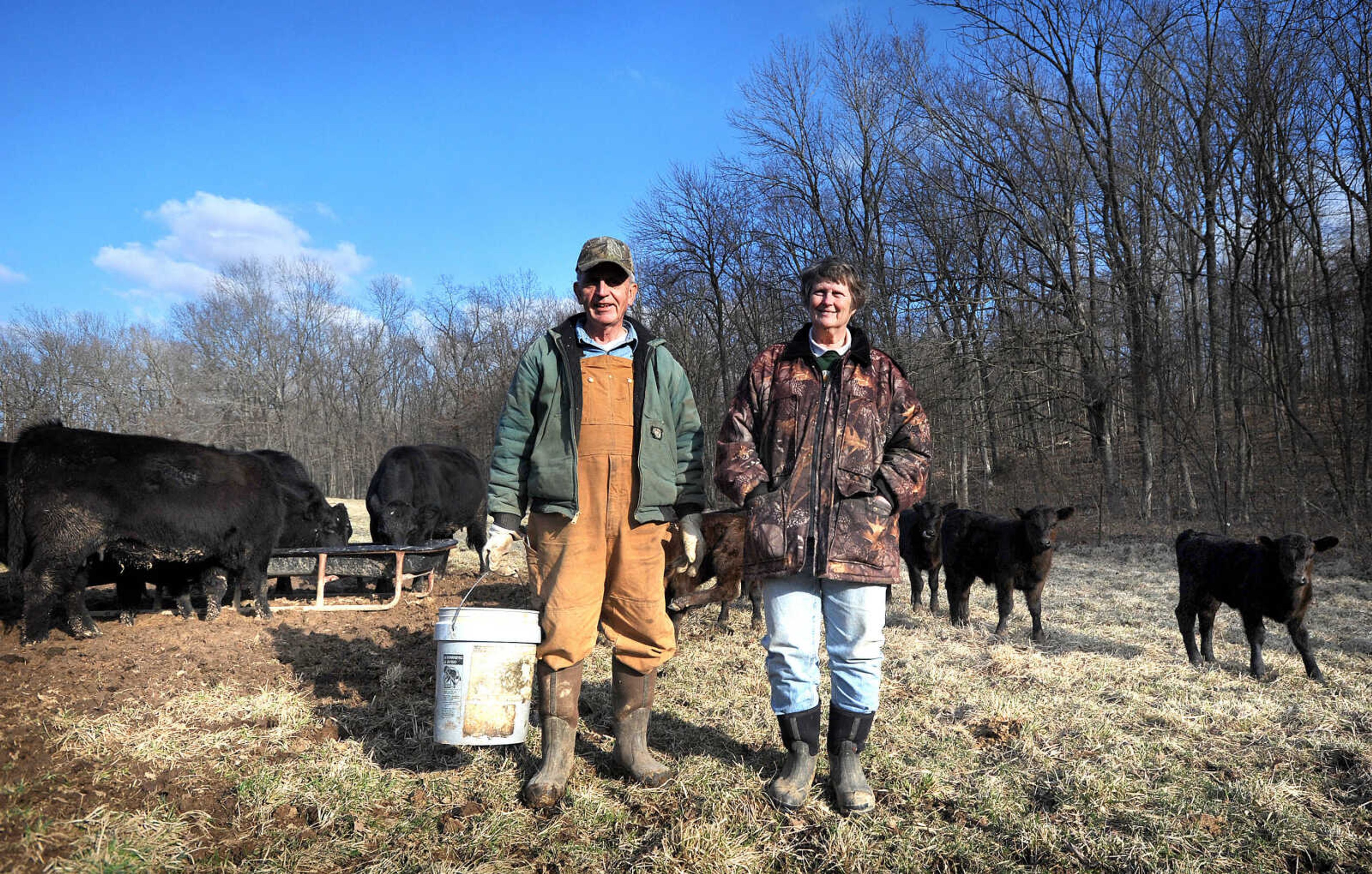 Gary and Sue Brewer stand among their black angus cattle on the Bollinger County farm. (Laura Simon)