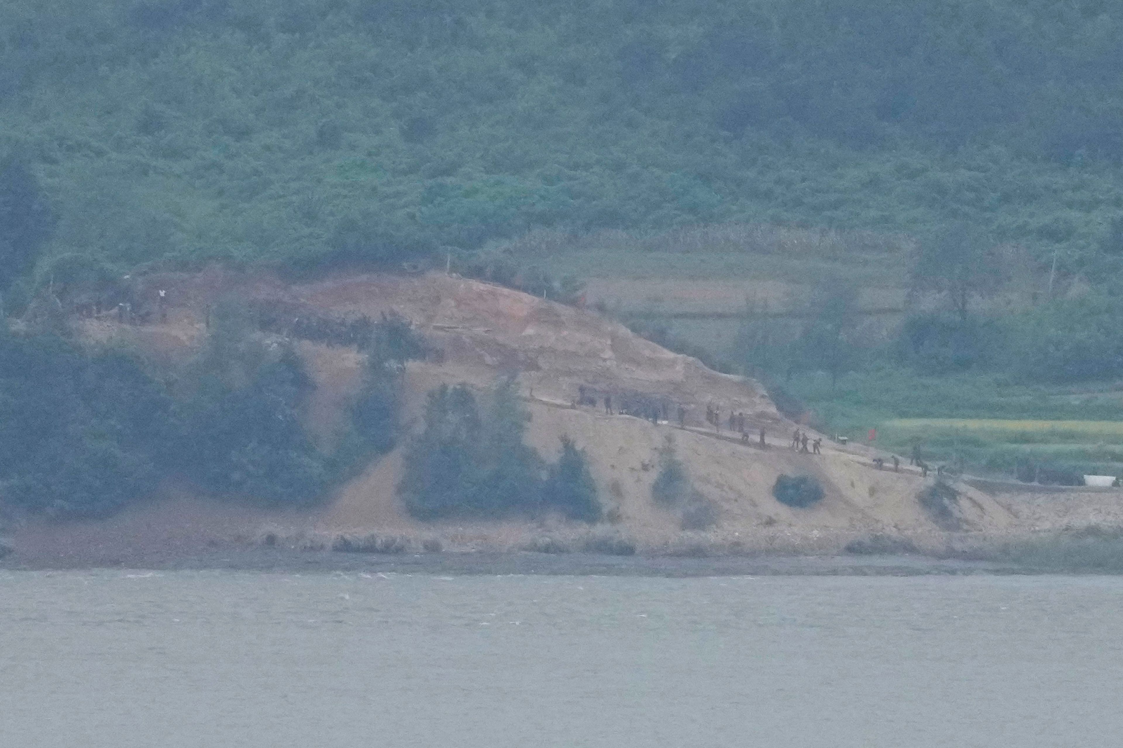 North Koreans, along the military fences, are seen from South Korea's Paju Thursday, Sept. 5, 2024. (AP Photo/Lee Jin-man)