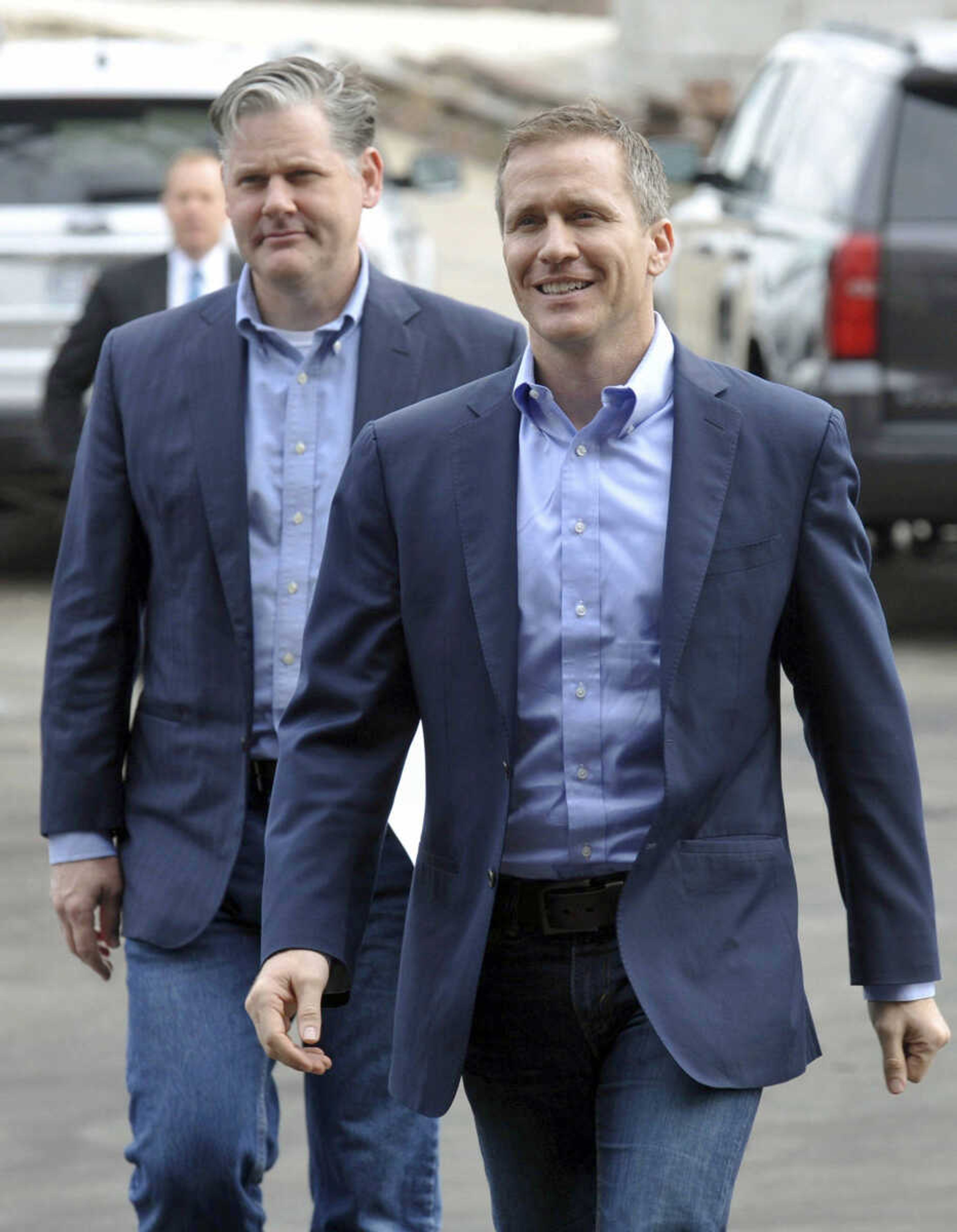 Gov. Eric Greitens, right, arrives for a news conference Wednesday in Jefferson City, Missouri, to announce his selection of Drew Erdmann, background left, as the state's first chief operating officer.