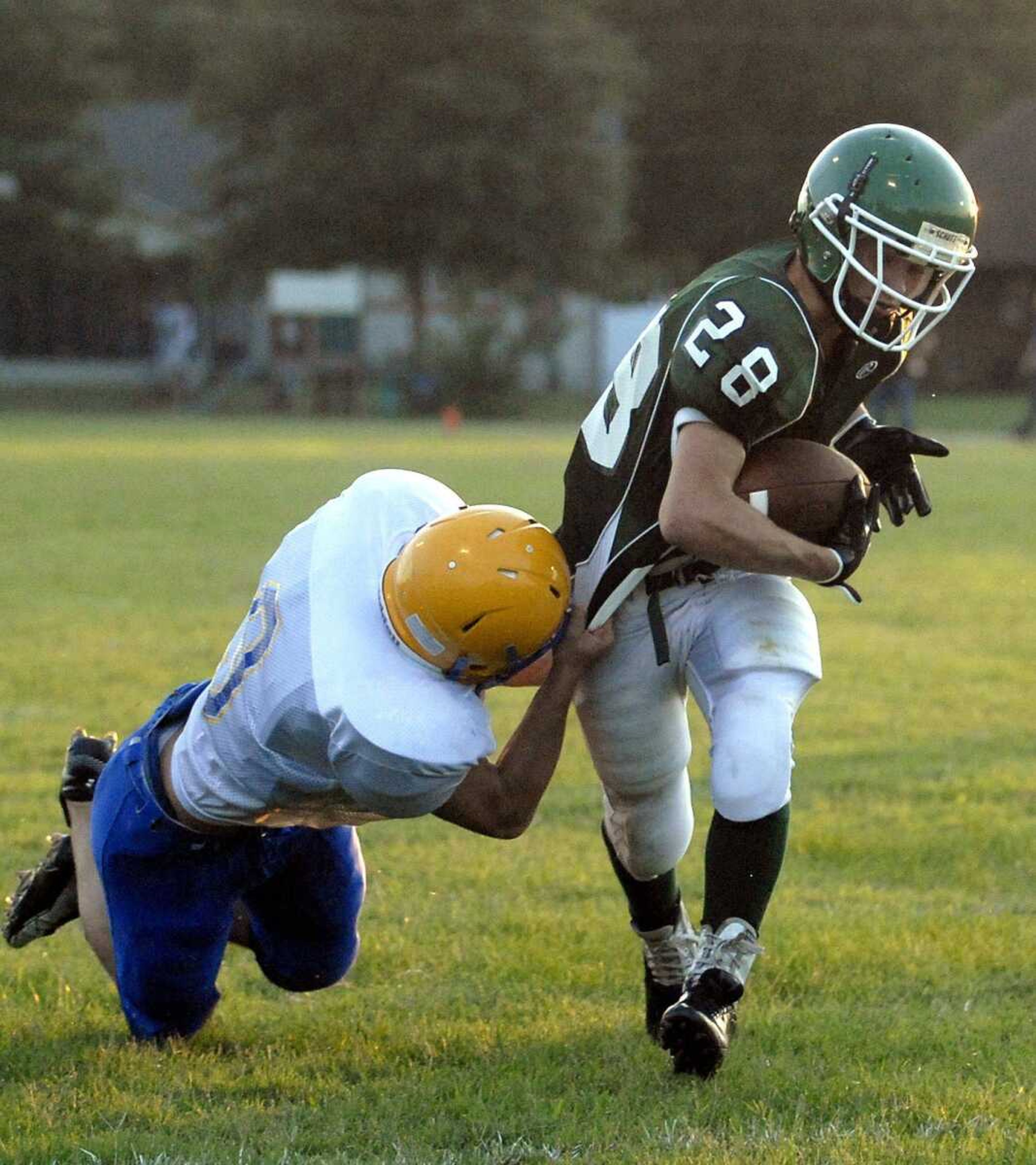 ABOVE: Scott City's Gordy Bradley tries to tackle Perryville running back Levi Zook during the jamboree Friday in Scott City.LEFT: St. Vincent's Jesse Francis is sandwiched between two Scott City defenders.BELOW: Perryville quarterback Chris Zahner drops back to throw.