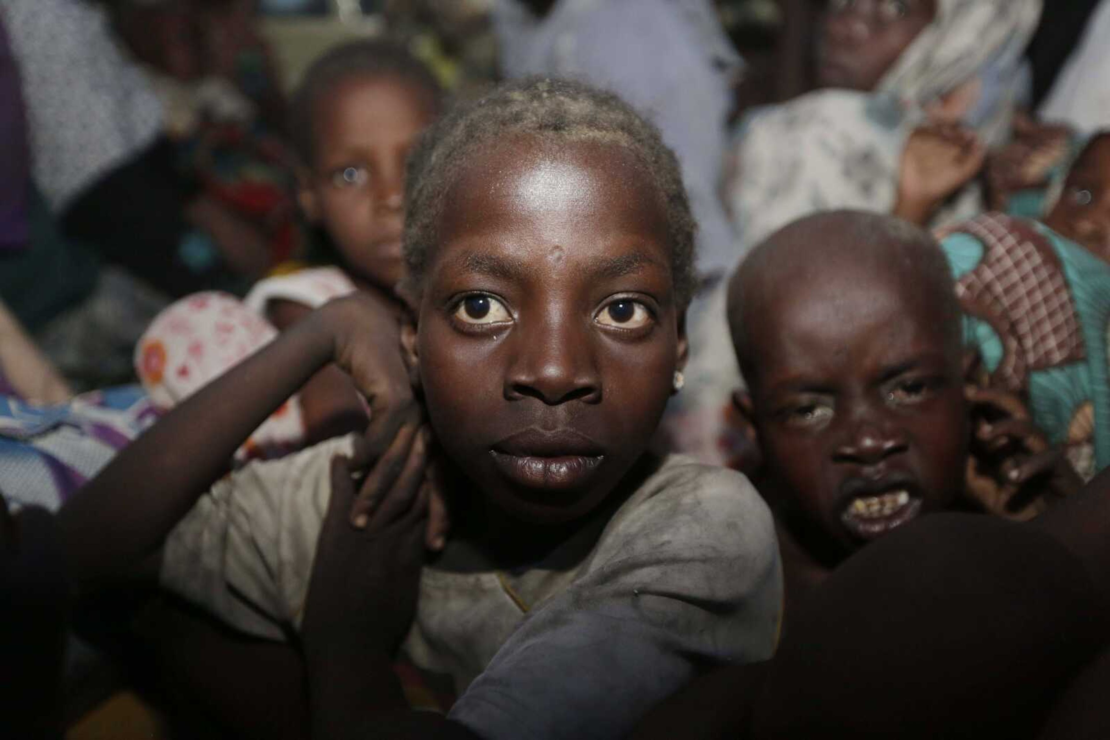 Women and children rescued by Nigeria soldiers from Islamist extremists at Sambisa Forest arrive at a camp Saturday in Yola, Nigeria. (Sunday Alamba ~ Associated Press)