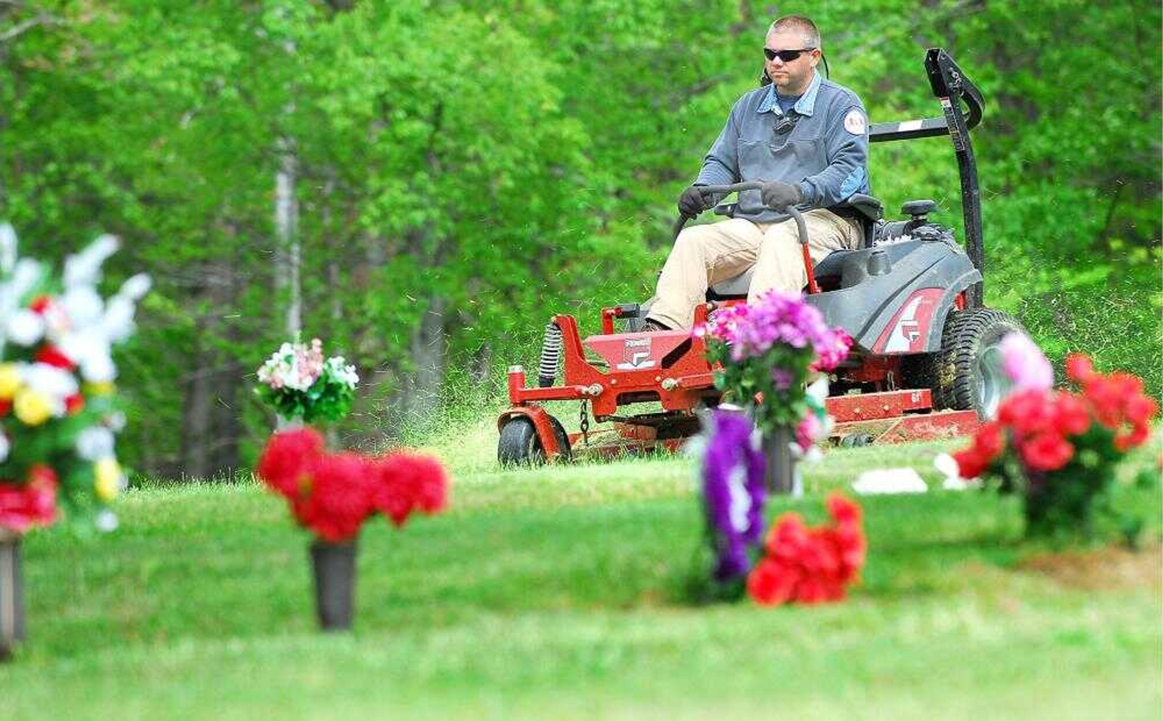 Scott County took over the Forest Hill Memorial Garden cemetery and hired Jim Walkins, who has family members buried there, to mow the grass while the county waits for a new buyer to take over. The cemetery, located near Morley, was known for its tall grass and other vegetation problems for the past few years before the court order made the local government to take care of the upkeep. (Diane L. Wilson)