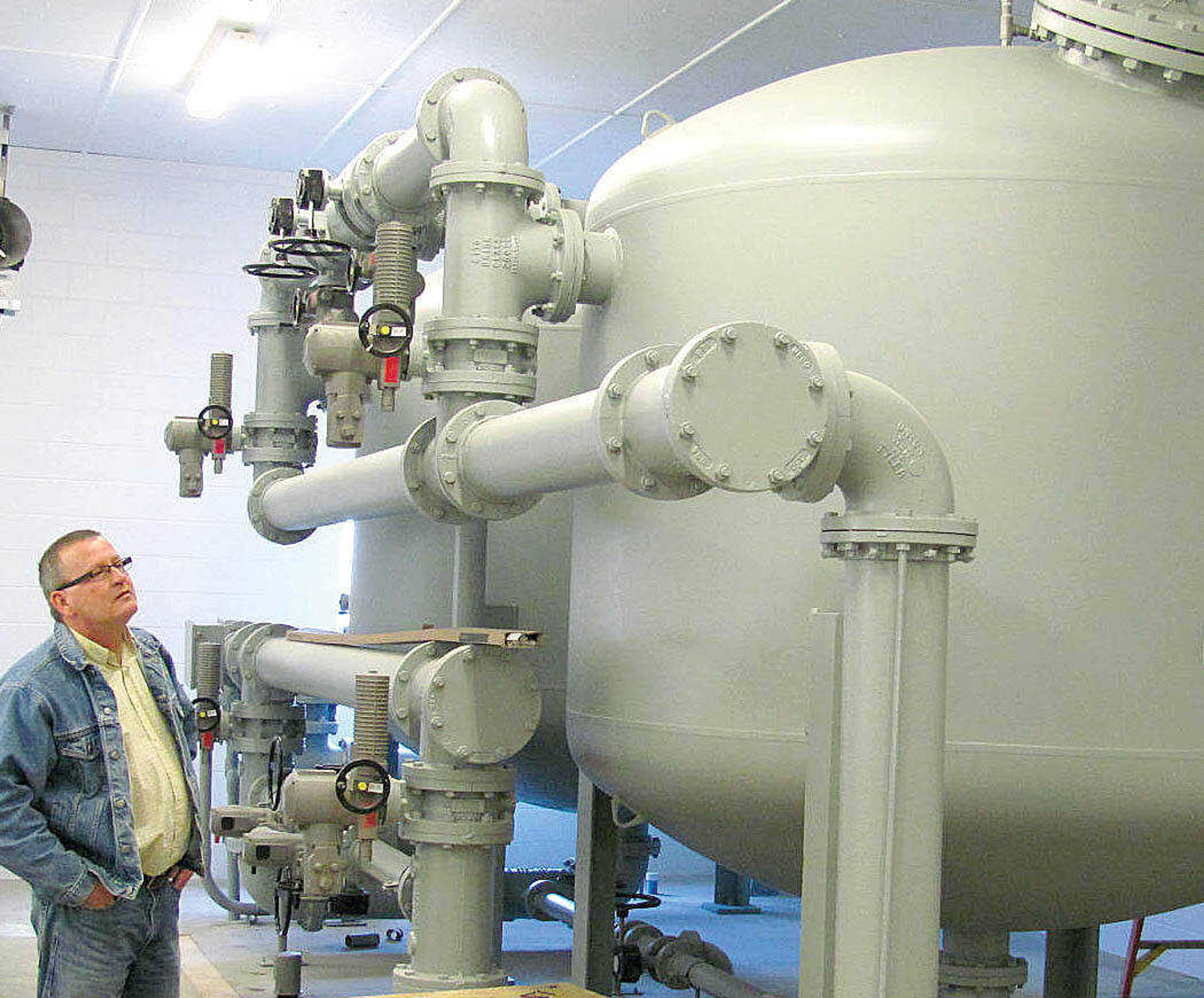 Tim McIntyre, systems manager for Public Water Supply District No. 4 in Scott County, talks about the two sand filters at the treatment plant in Haywood City. There is space to add two additional filters as demand increases. Work is progressing on PWSD No. 4, with the storage tank erected and set to be finished in just a couple of weeks, and Phase One of the project set for a late summer completion date.
(Photo by Michelle Felter, Standard Democrat)