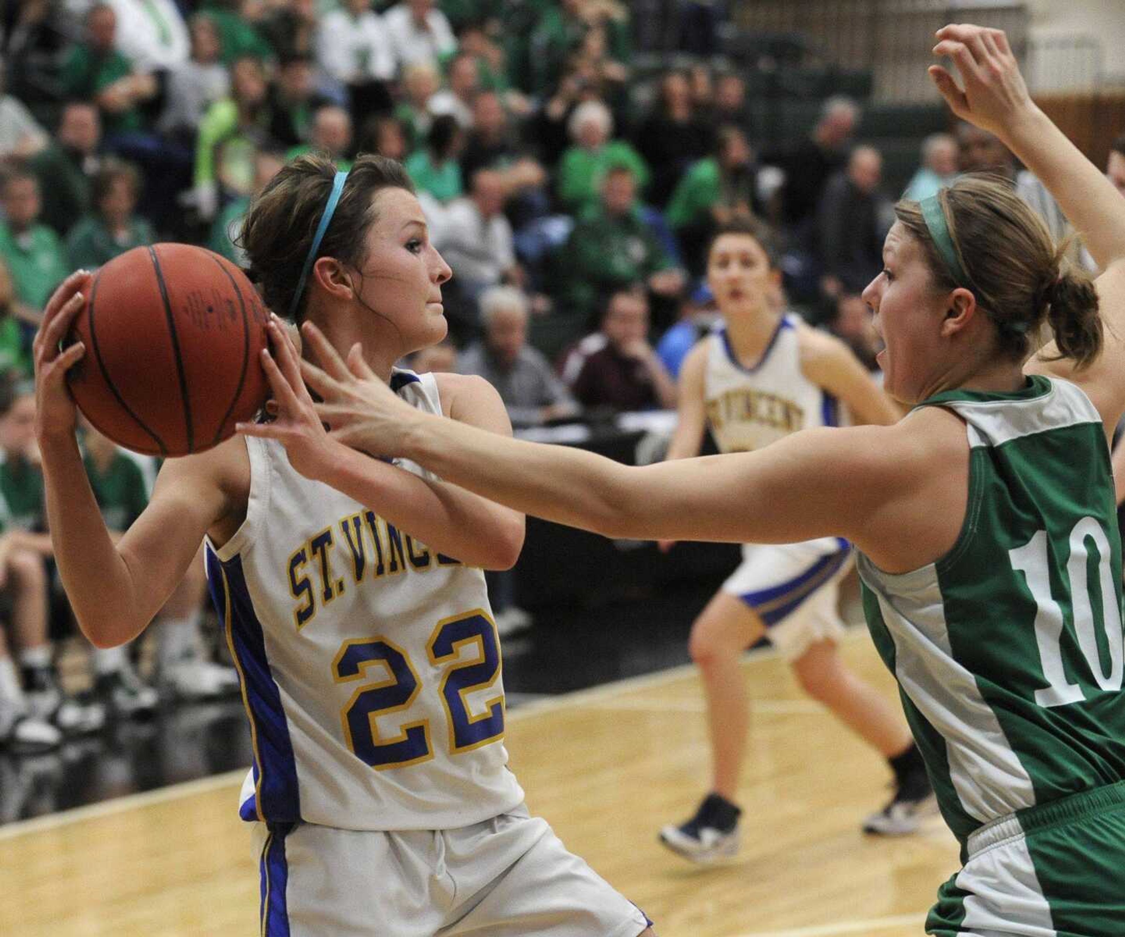 St. Vincent's Storm French looks to pass as New Haven's Julie Scheer defends during the second quarter of the Class 2 District 4 title game Friday, March 4, 2011 in Perryville, Mo. (Fred Lynch)