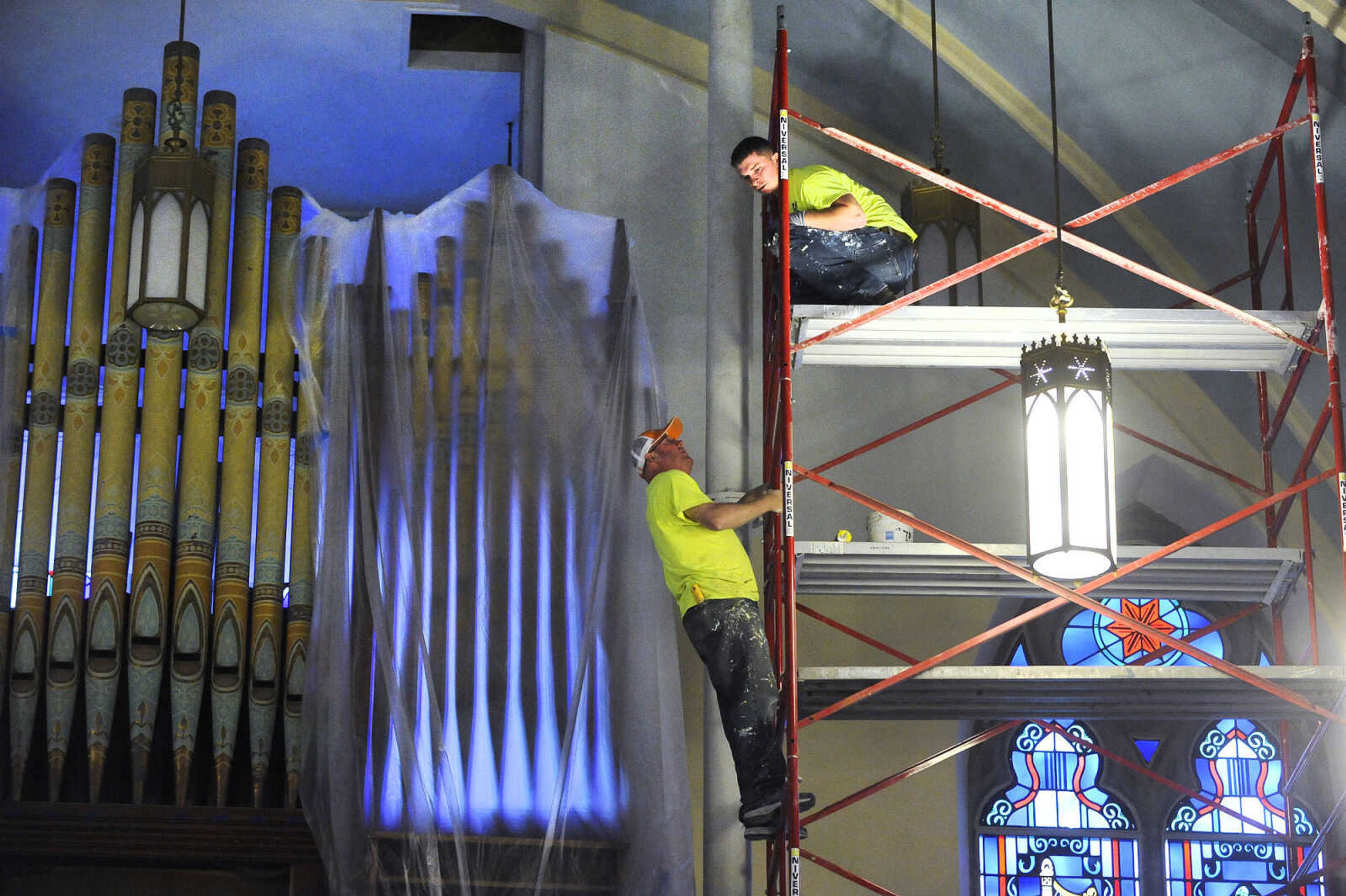 LAURA SIMON ~ lsimon@semissourian.com

Brad Earnhardt, left, and Kyle Thompson chat on the scaffolding in the choir loft of St. John's Catholic Church in Leopold, Missouri on March 4, 2016.