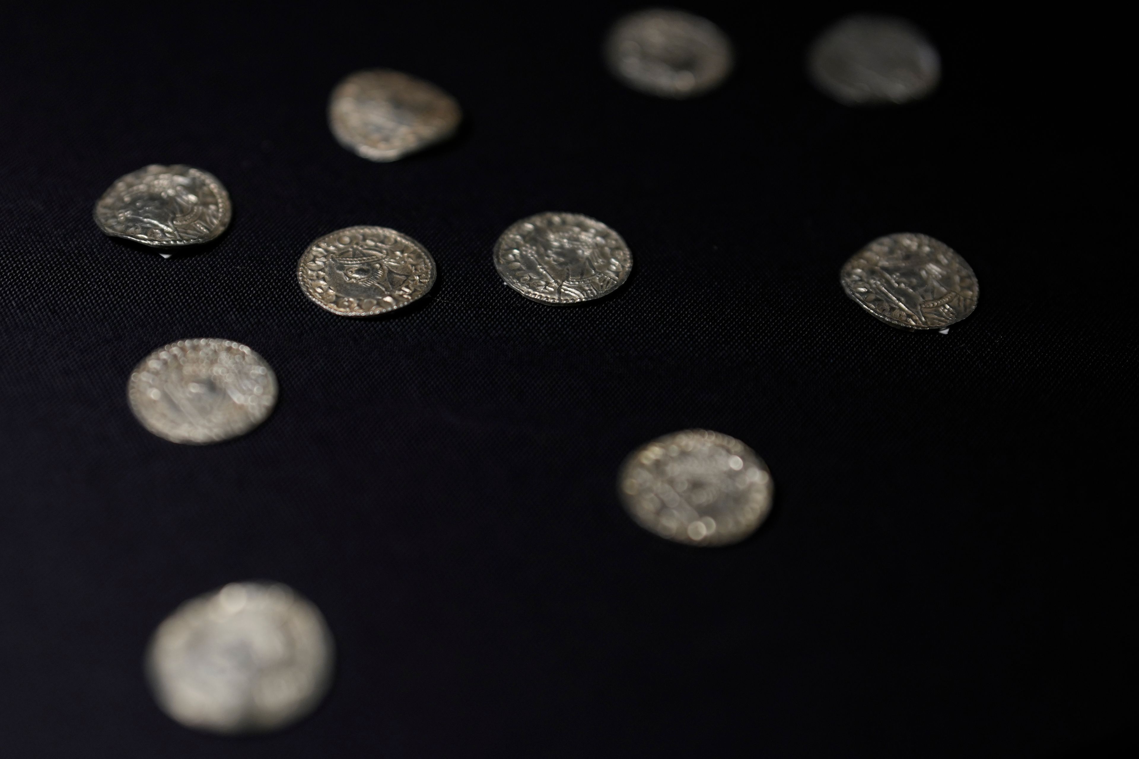 A selection of coins dating from the time around the Norman Invasion of Britain in 1066, which are part of the Chew Valley Hoard of 2,584 coins, on display at the British Museum in London, Tuesday, Oct. 22, 2024, the hoard is valued at £4.3 million pounds, (US$5.58 million), a record find. (AP Photo/Alastair Grant)