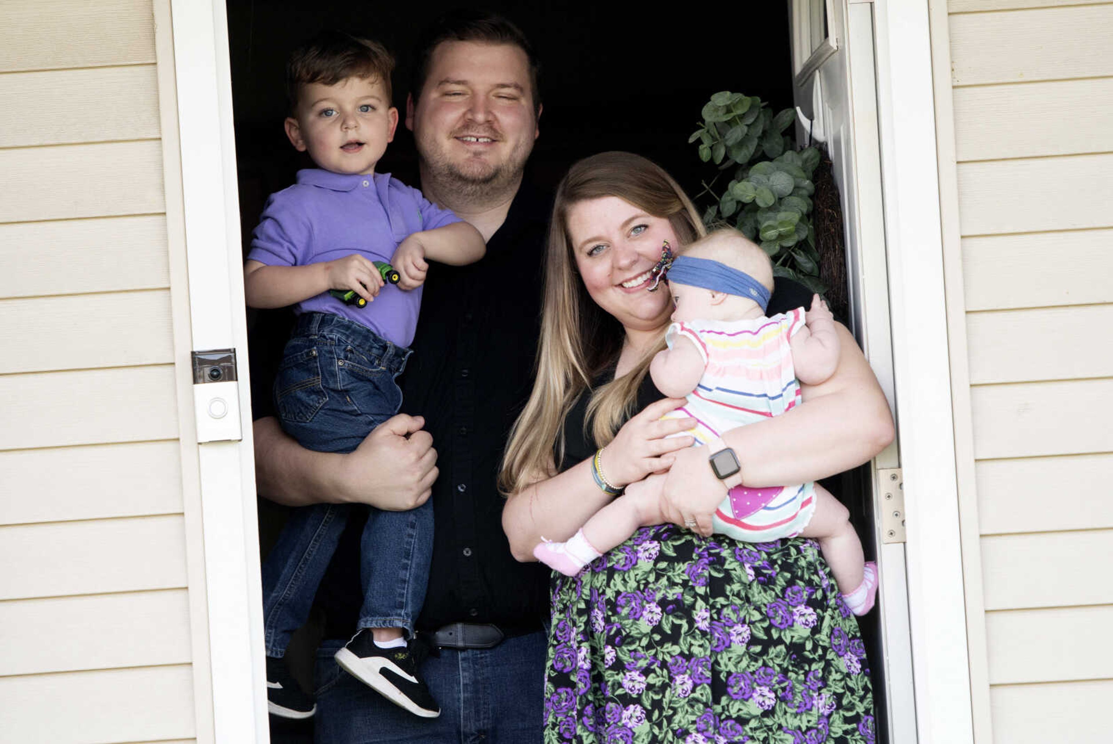 Adam and Olivia Carter pose for a portrait with their children Evan, 3, and Addison, 7 months, on Wednesday, April 8, 2020, at their Jackson home.