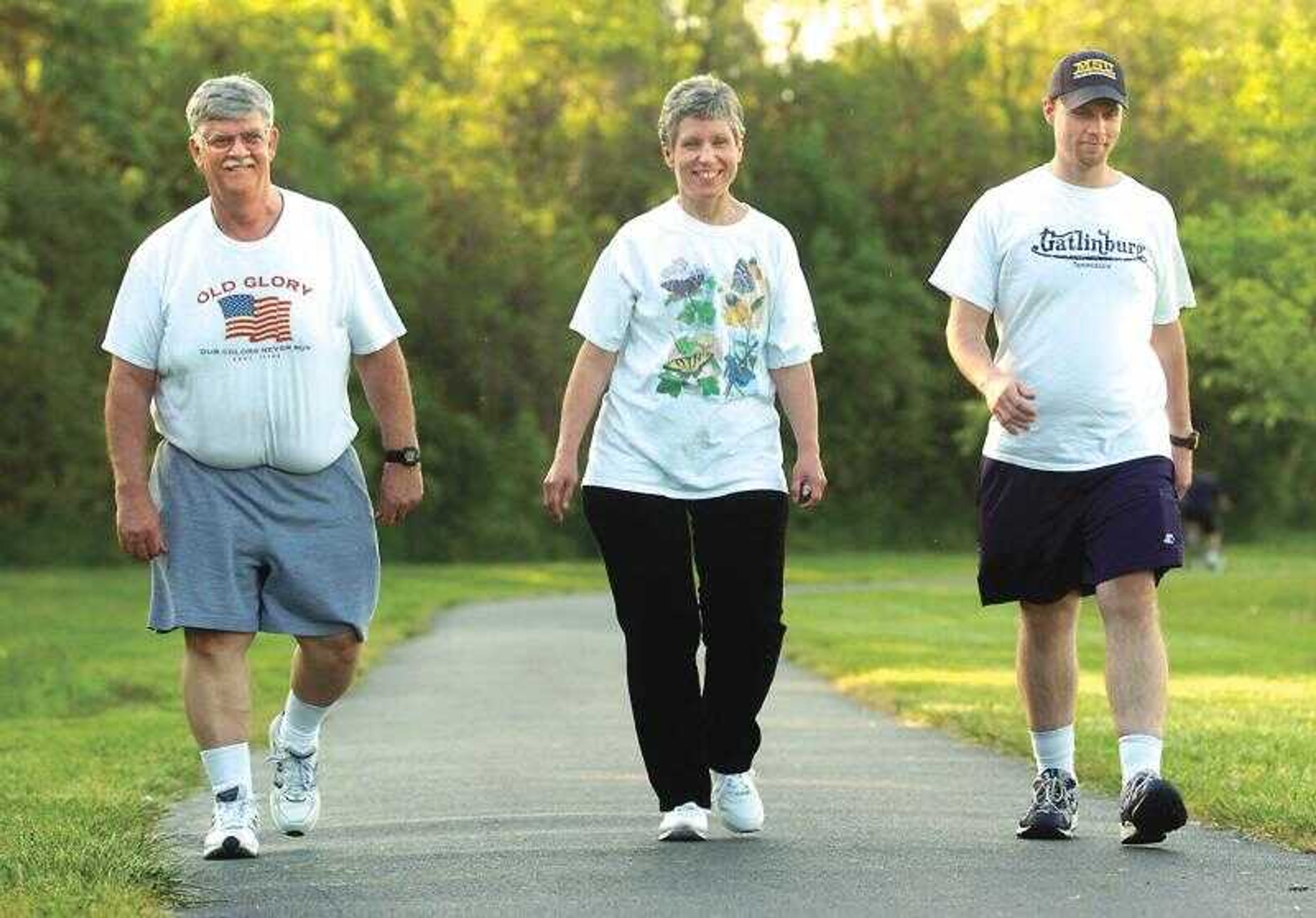 Cliff Lankheit, left, his wife, Melanie, and son, Kevin, walked along the Cape LaCroix Recreational Trail which the family has used to help them lose weight through exercise along with diet control.