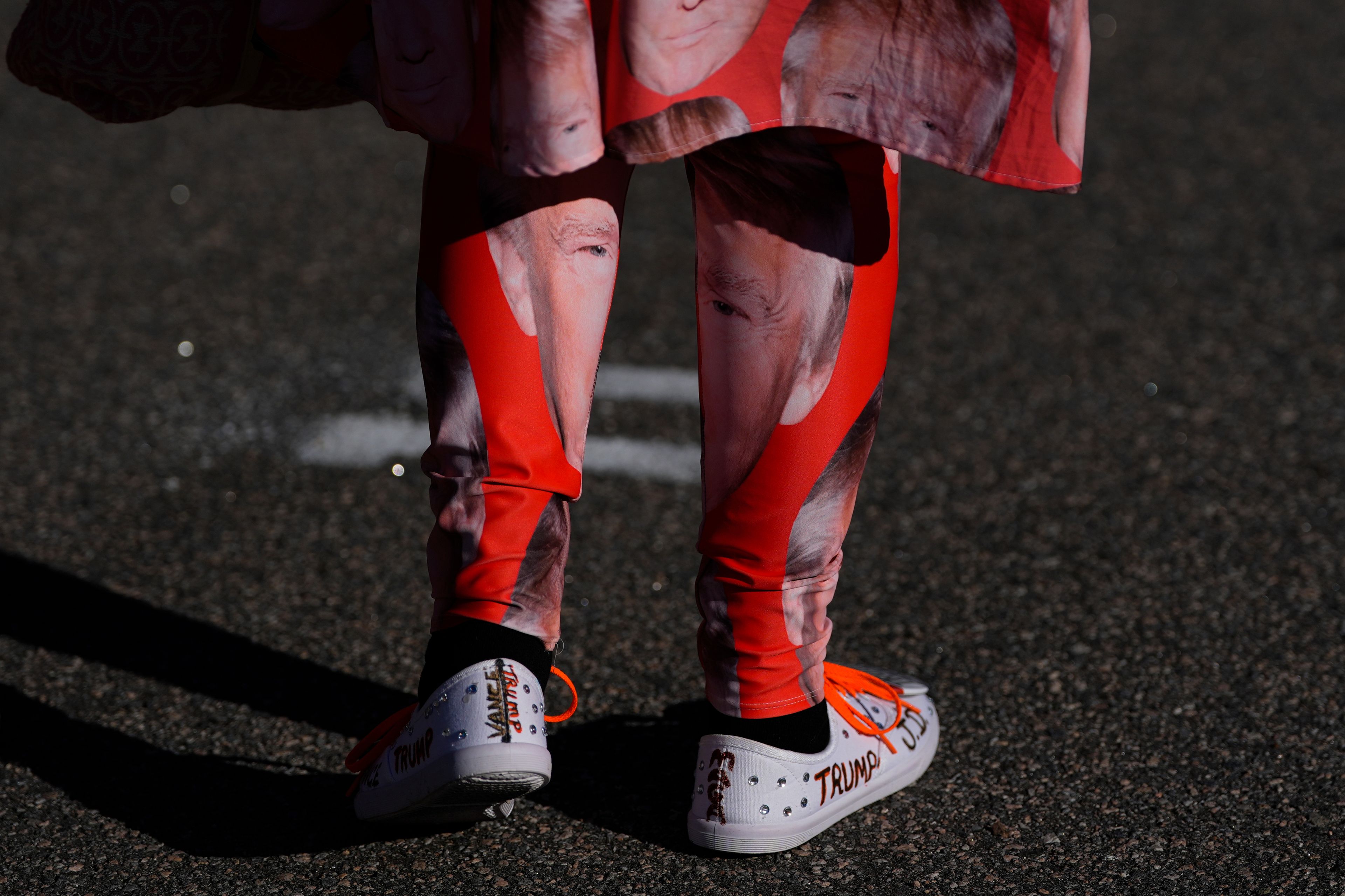 A supporter of Republican presidential nominee former President Donald Trump walks to enter a campaign rally at Minges Coliseum, Monday, Oct. 21, 2024, in Greenville, N.C. (AP Photo/Julia Demaree Nikhinson)