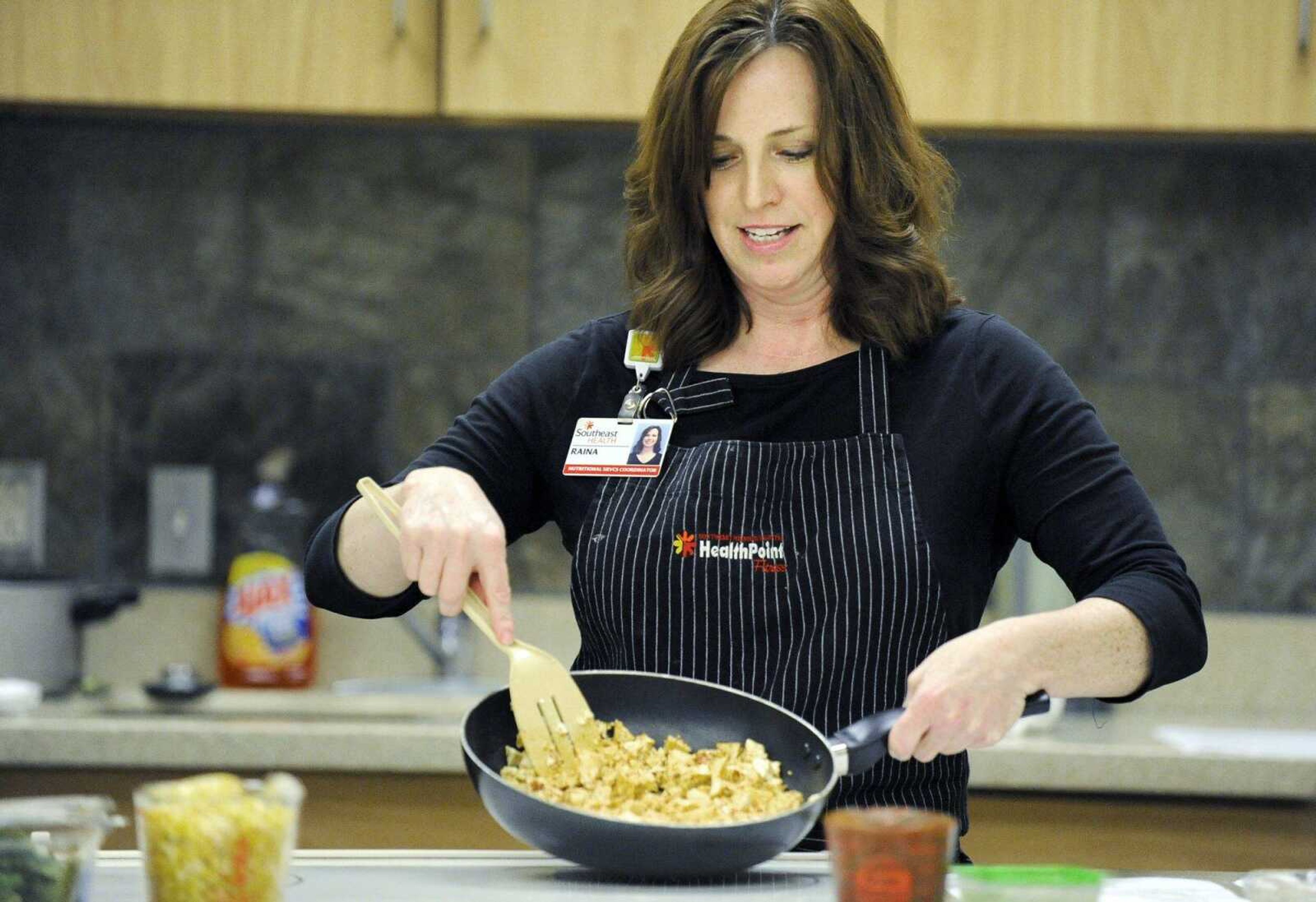 Raina Childers shows her students the chopped tofu she is preparing for tofu tacos on Monday, May 30, 2016, during her tofu cooking class at HealthPoint Fitness in Cape Girardeau.