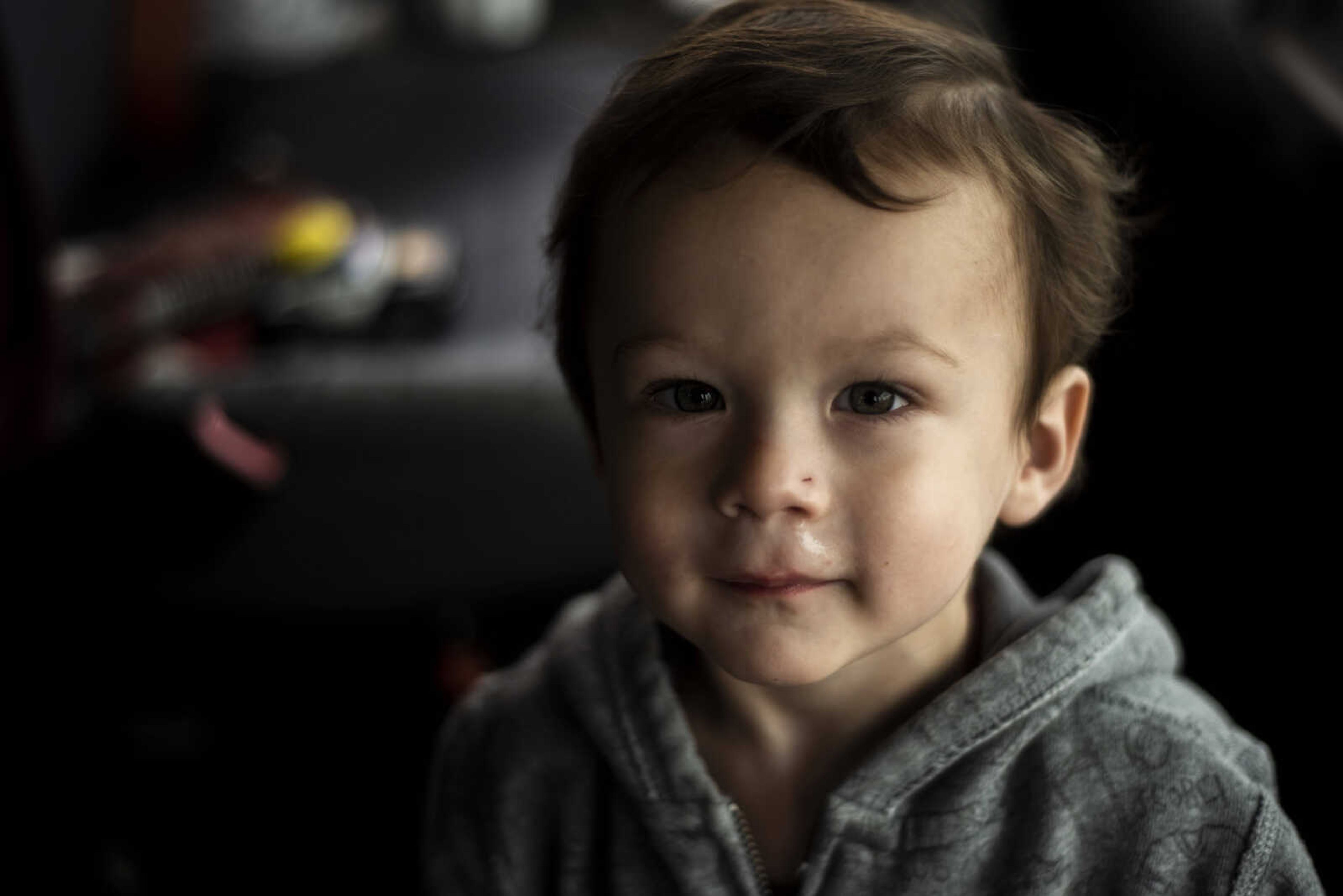 Andrew Askew, 2, looks at the camera while waiting on his grandmother Kelly Elizalde's bus before shuttling rally attendees from West Park Mall to the Show Me Center Monday, Nov. 5, 2018, in Cape Girardeau. Askew is the great-grandson of Mexican immigrants. His grandfather, Elizalde's husband, was born and raised in America by his parents who came to the US, and Elizalde said she's always had a bad taste in her mouth surrounding President Trump with the way he speaks about women and immigrants.