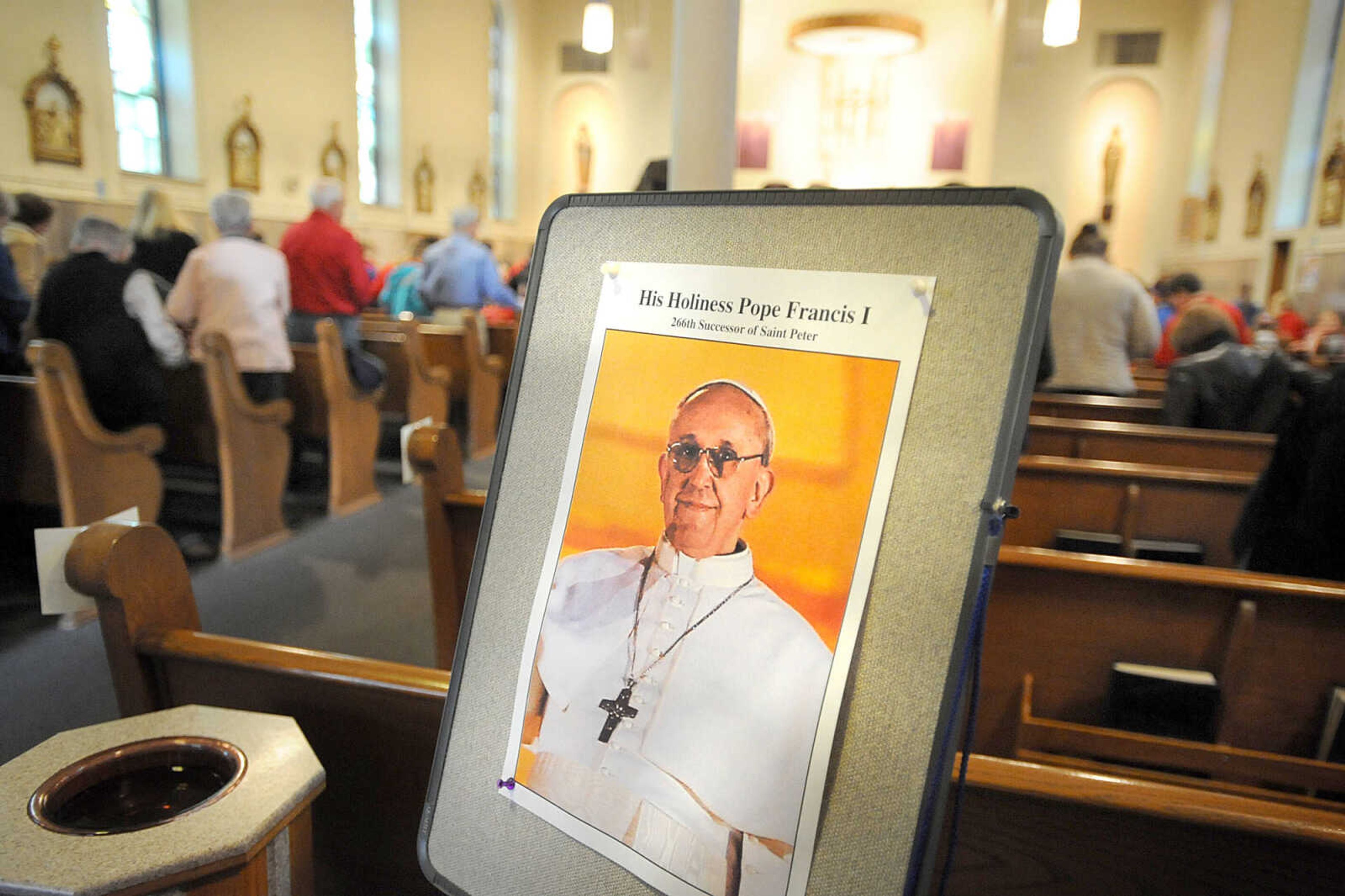 LAURA SIMON ~ lsimon@semissourian.com
A photo of Pope Francis I greets parishioners as they enter St. Mary's Cathedral Friday morning, March 15, 2013 during the Mass of Thanksgiving in Cape Girardeau. The mass was in honor of the election of Pope Francis I.