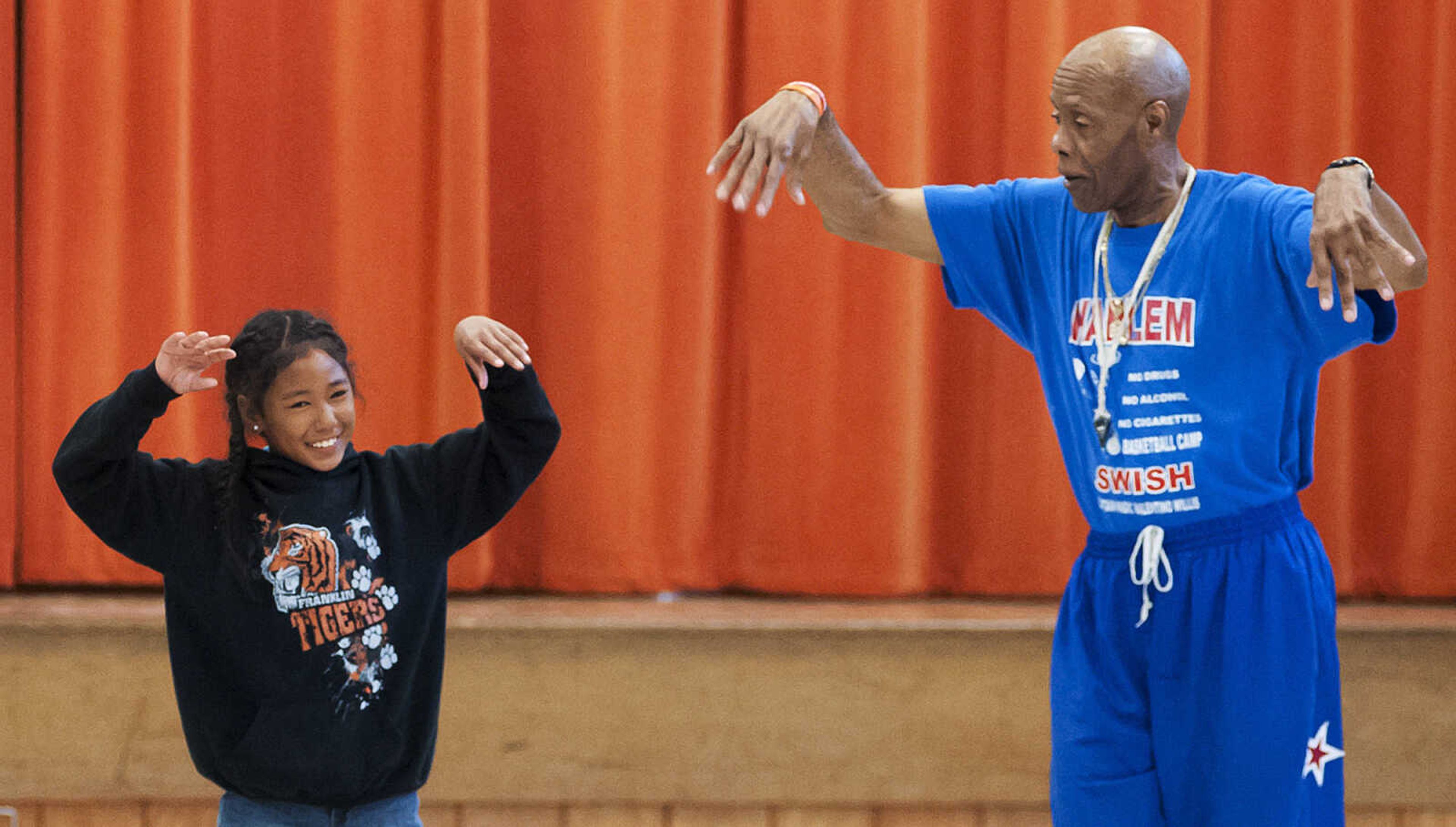 Captain "Magic" Valentino Willis gets some help from Briaysia Purl during his presentation at Jefferson Elementary School Tuesday, Sept. 24, in Cape Girardeau. Willis, who is with the Harlem Swish Comedic Basketball Team, used his basketball and comedy skills to encourage the students to not smoke, drink or do drugs while respecting their teachers, principals, coaches and each other.