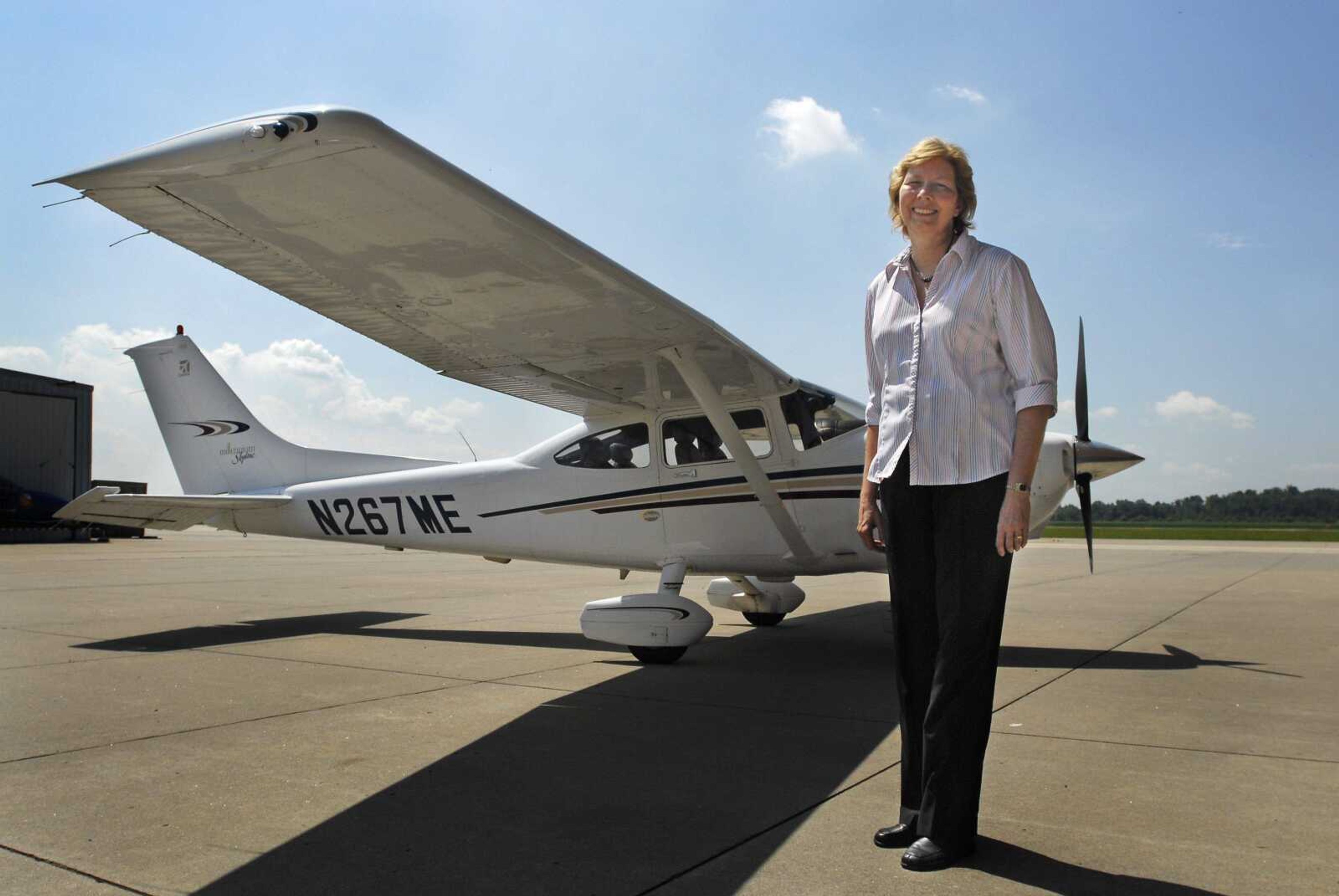 Pilot and flight instructor Beverly Cleair stands alongside the Cessna 182 that she and race partner Teresa Camp will fly in the Air Race Classic, an all-female race that celebrates women's contributions to aviation. The pair will raise money for Wings of Hope. The race begins in Fort Myers, Fla., and ends in Frederick, Md. (Kristin Eberts)