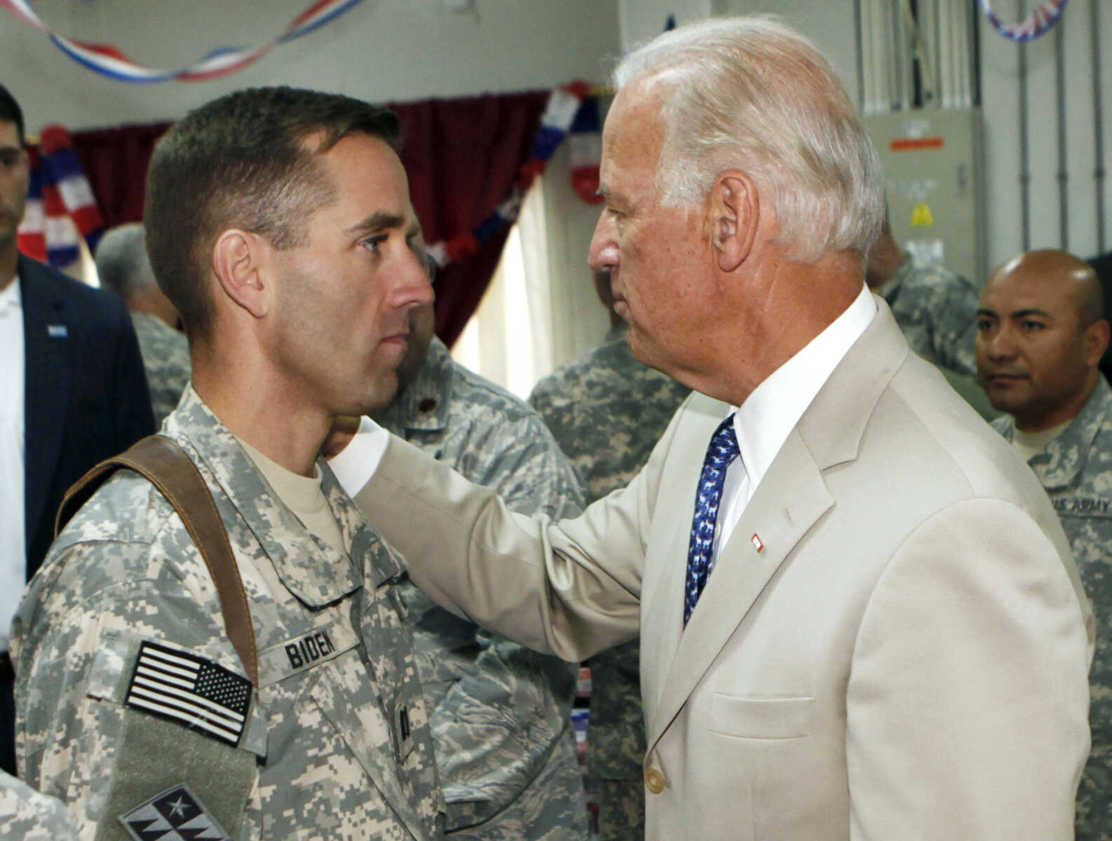 U.S. Vice President Joe Biden, right, talks with his son, U.S. Army Capt. Beau Biden, on July 4, 2009, at Camp Victory on the outskirts of Baghdad, Iraq. On Saturday, May 30, 2015, Vice President Biden announced the death of son, Beau, from brain cancer. (AP Photo/, Pool) (Khalid Mohammed ~ Associated Press, pool)