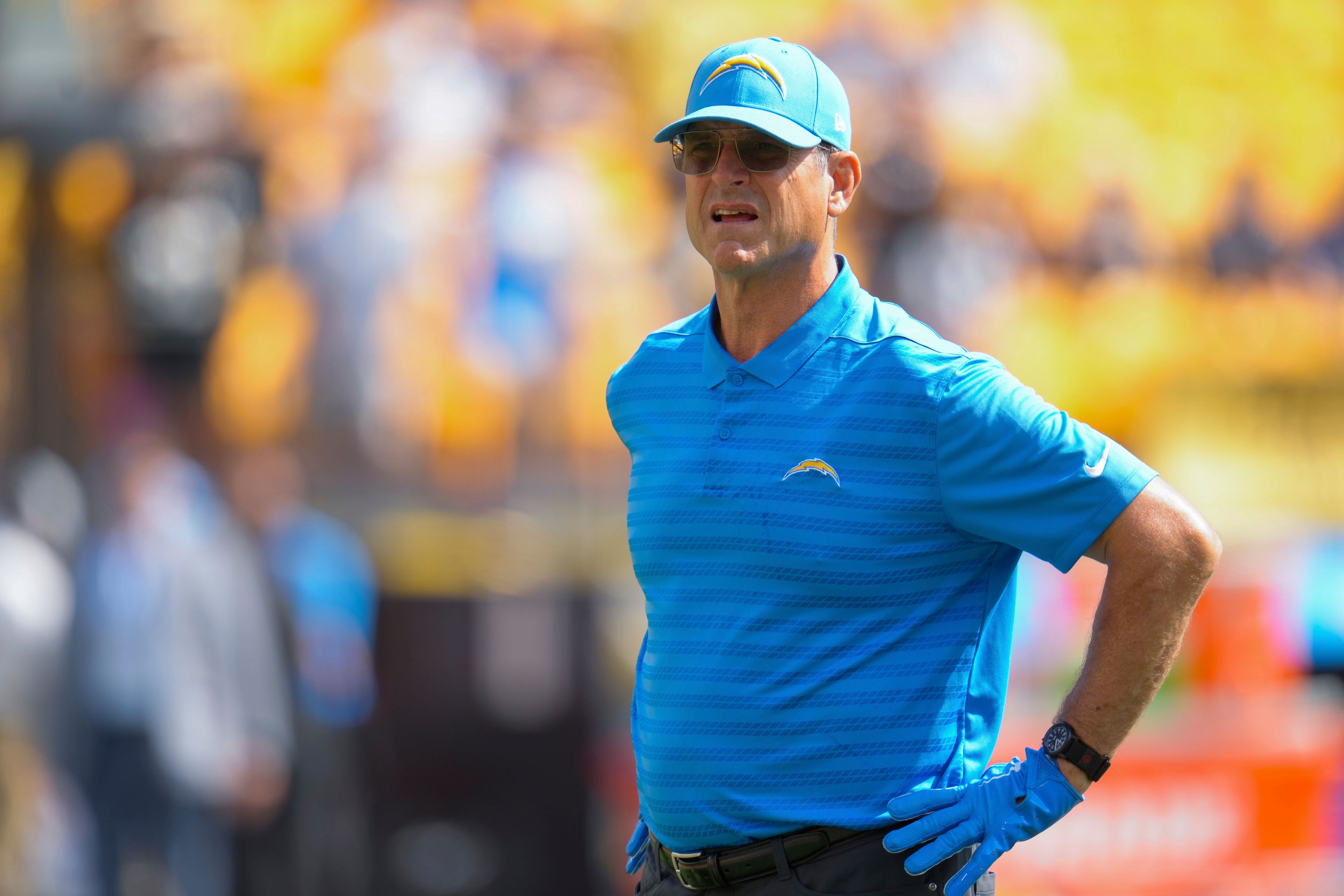 Los Angeles Chargers head coach Jim Harbaugh watches as players warm up before an NFL football game, Sunday against the Pittsburgh Steelers in Pittsburgh, Sept. 22, 2024. (AP Photo/Gene J. Puskar)