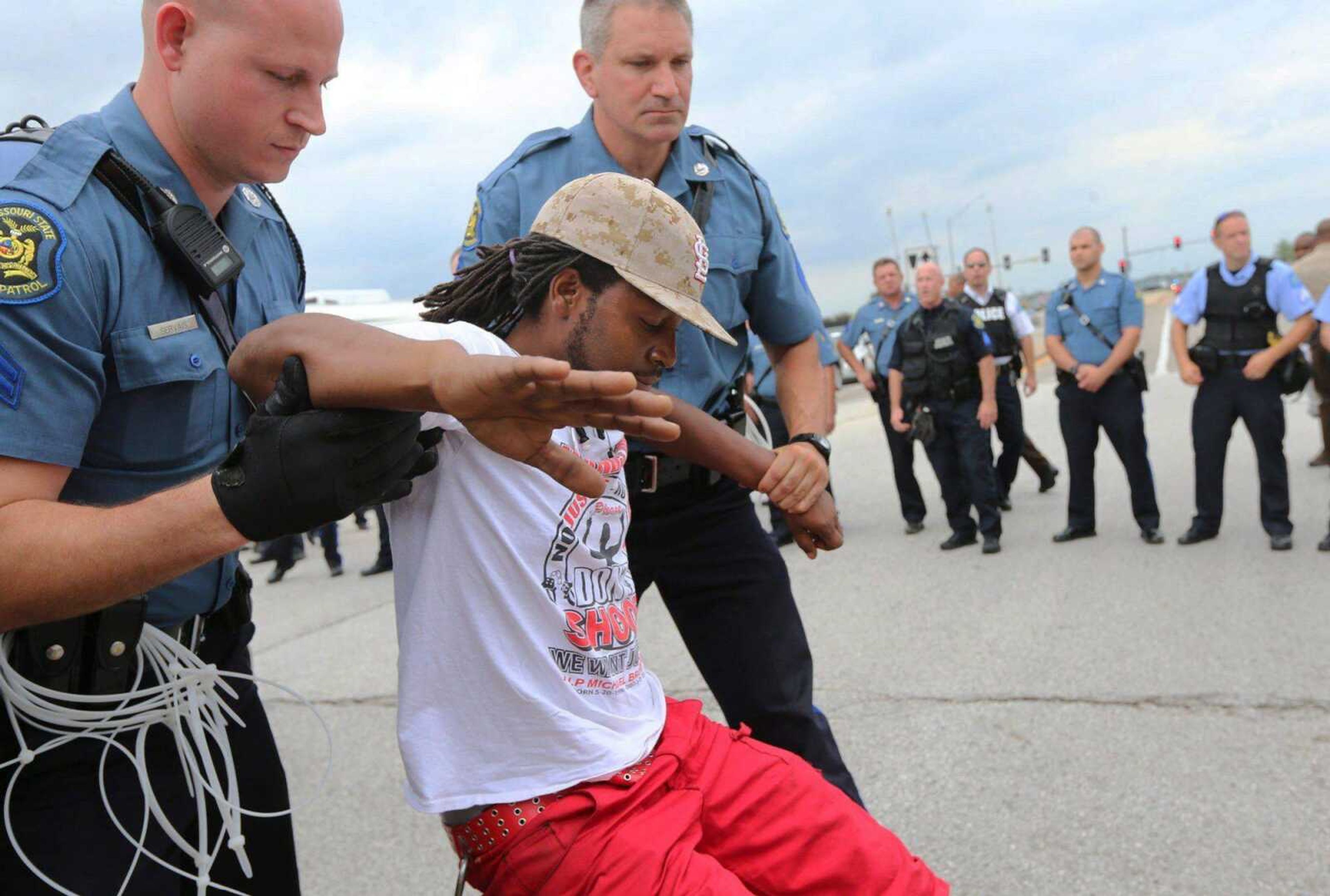 A man is arrested during a protest at Hanley Road and Interstate 70 during an attempt to shut down Interstate 70 in Berkeley, Missouri, on Wednesday near the St. Louis suburb of Ferguson where Michael Brown, an unarmed, black 18-year-old was shot and killed by a white police officer on Aug. 9. (AP Photo/St. Louis Post-Dispatch, David Carson)