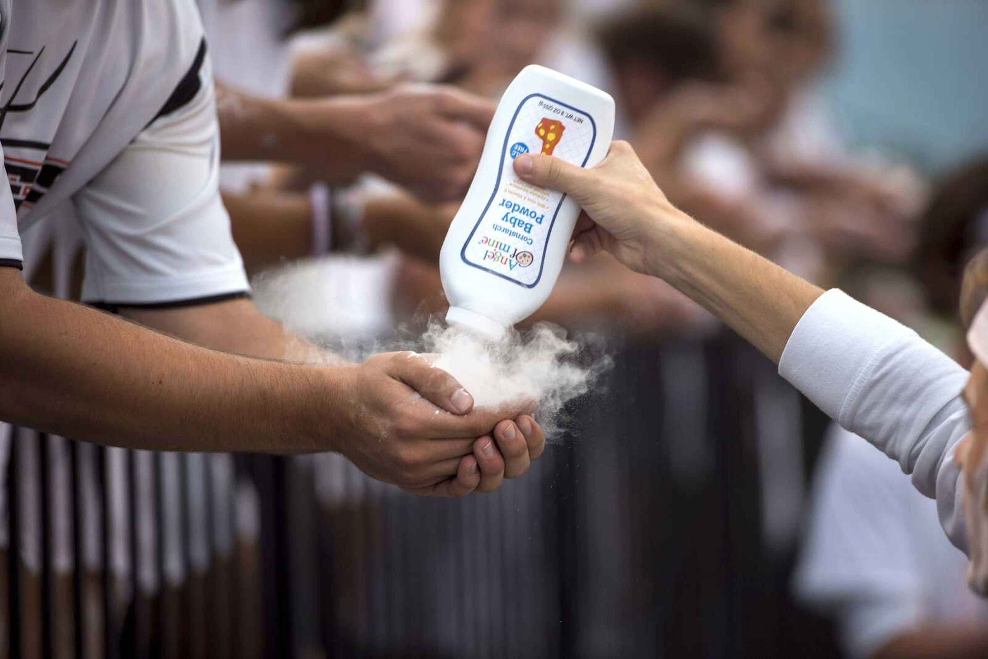 Cape Central students distribute baby powder (which they would later toss in the air) before the Cape Central Tigers' first home football game.