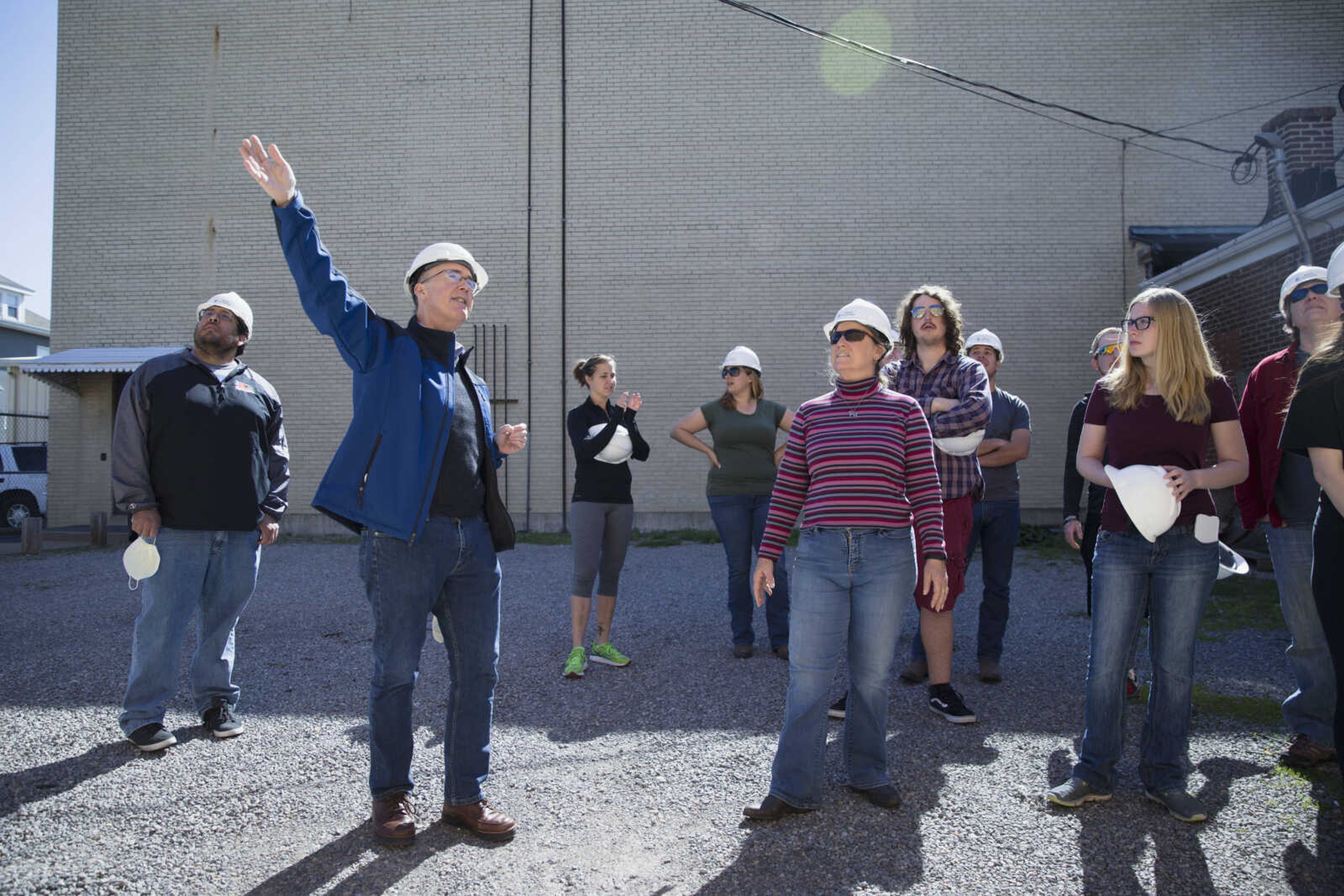 Dr. Steven Hoffman and a group of students from Southeast Missouri State University's historic preservation program survey the exterior of the Esquire Theater in Cape Girardeau.