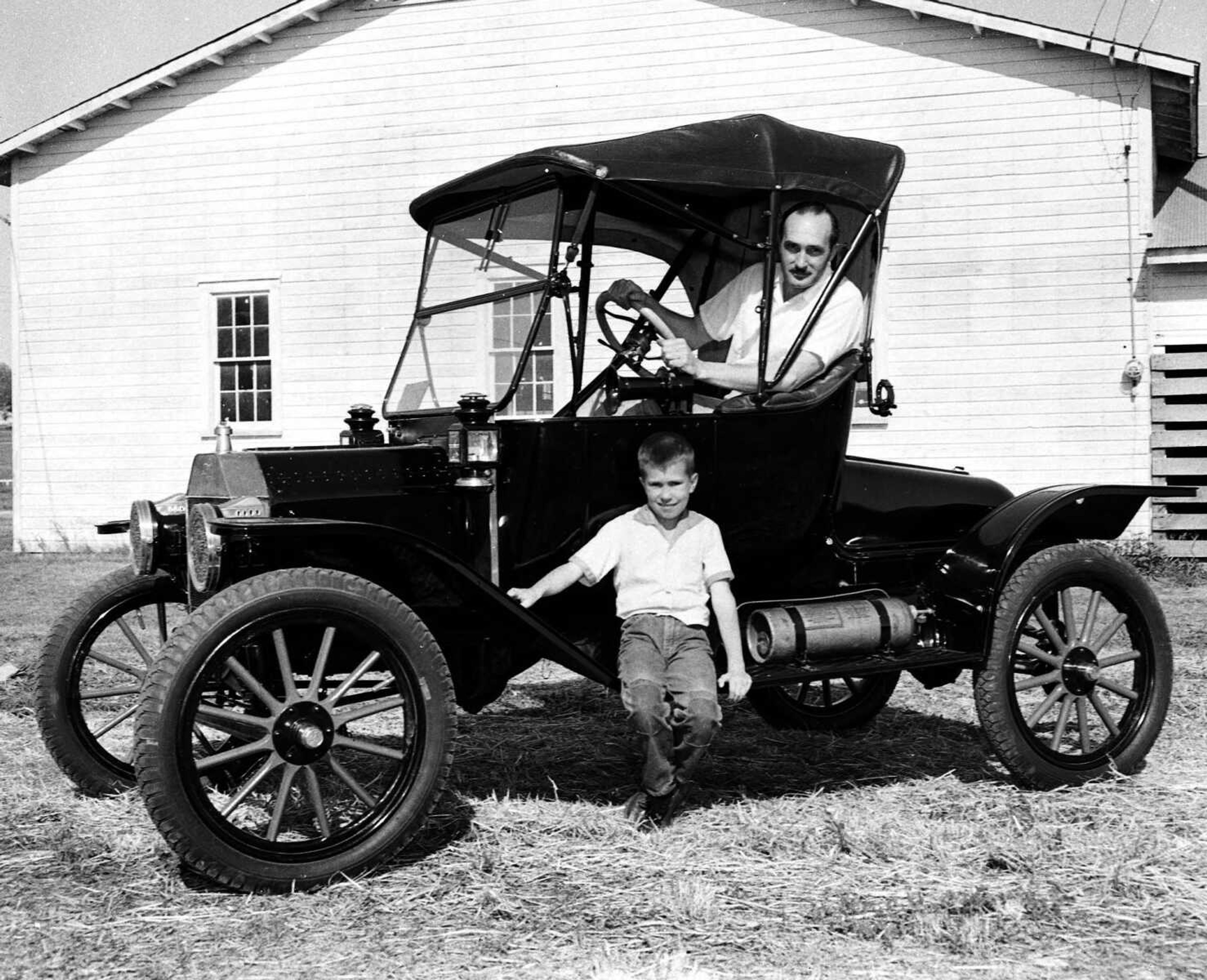 Joe D. James and son, John, posed with Joe's 1913 Ford roadster in May 1957. The elder James was preparing to ship the car to the Midwest Automotive Trade Show in St. Louis.