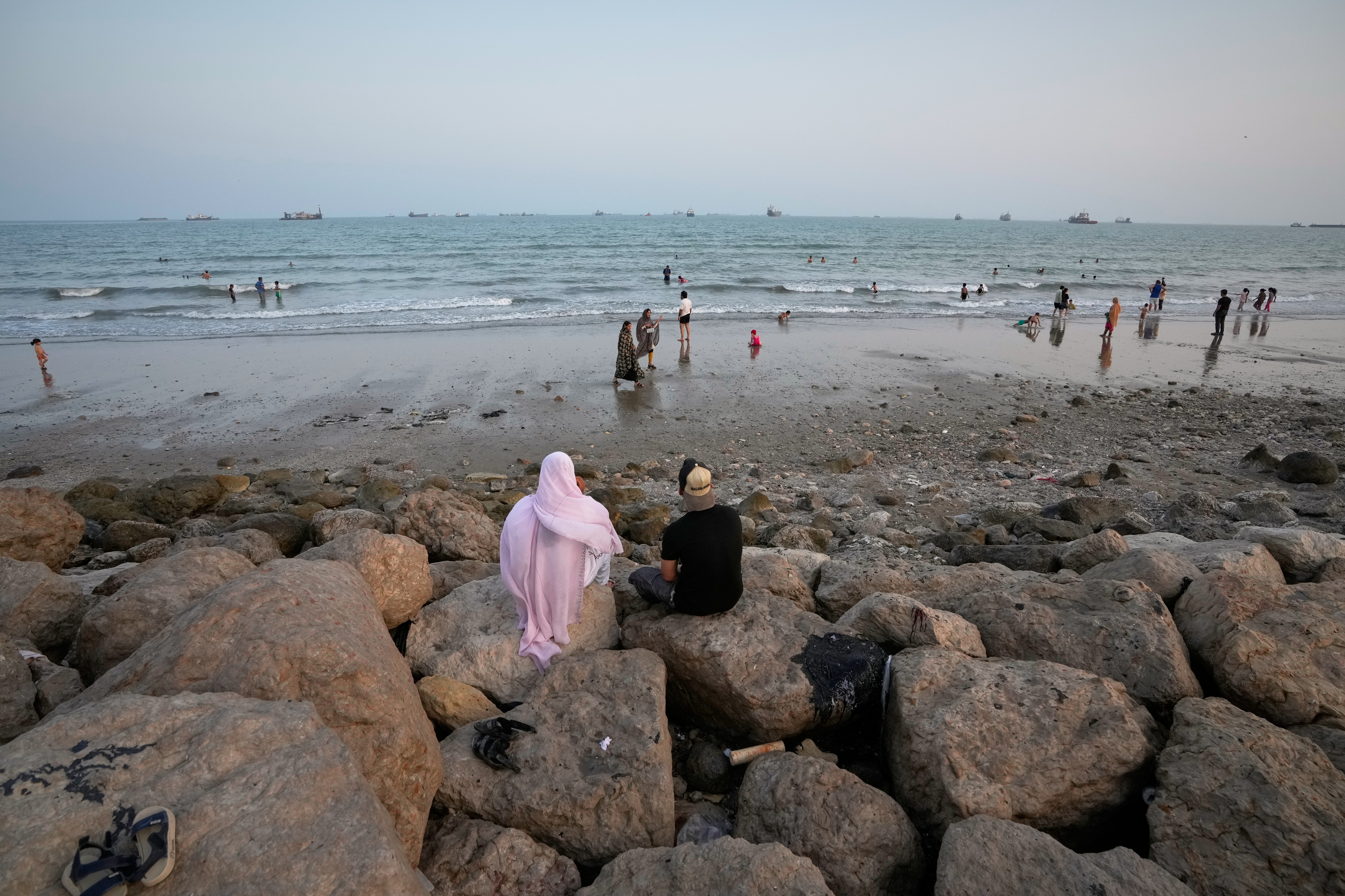 Photos show daily life in Iran on the beach along the Strait