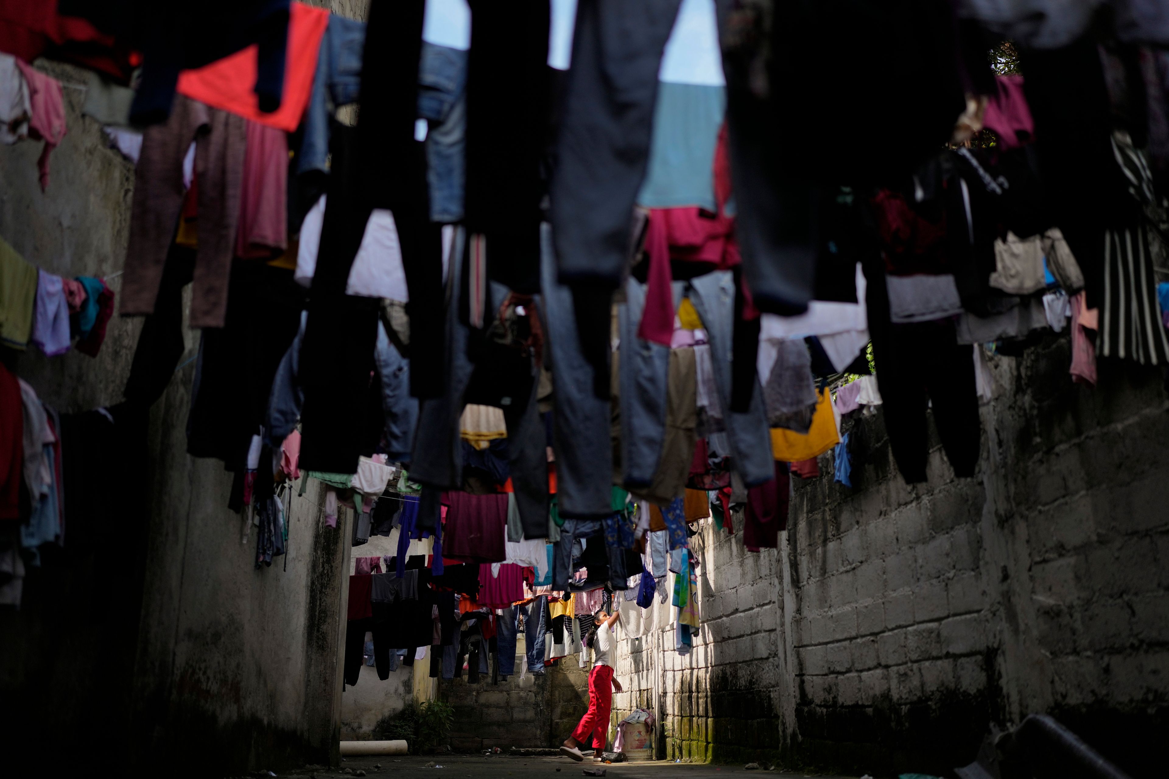 Honduran migrant Anyi Espinal dries her clothes in a shelter in Tapachula, Mexico, Monday, Oct. 28, 2024. (AP Photo/Matias Delacroix)