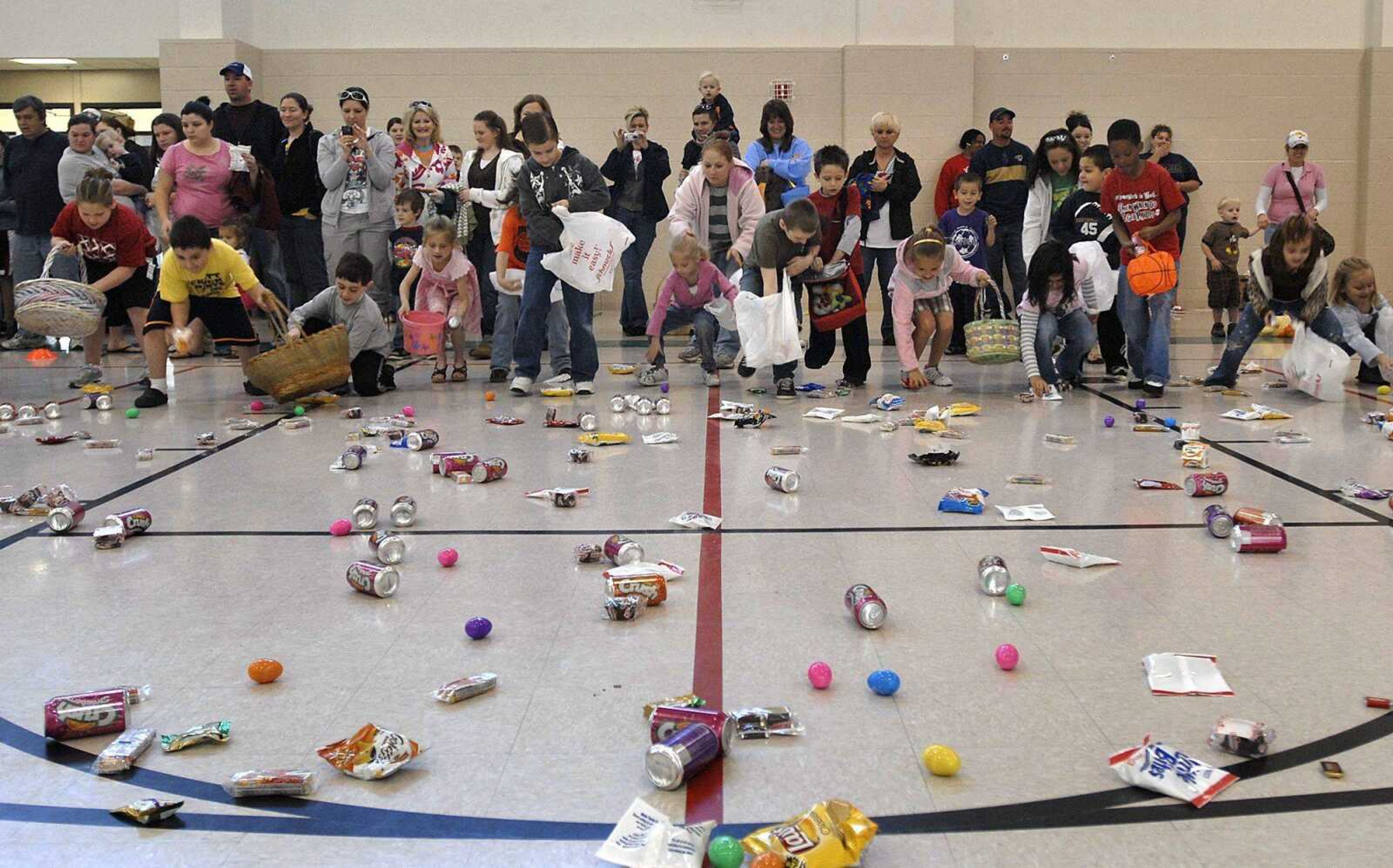 Children begin collecting Easter eggs and prizes at the annual Schnucks Easter egg hunt Saturday at the Osage Community Centre. More photos from the hunts are available in a gallery at semissourian.com.<br>FRED LYNCH<br> flynch@semissourian.com