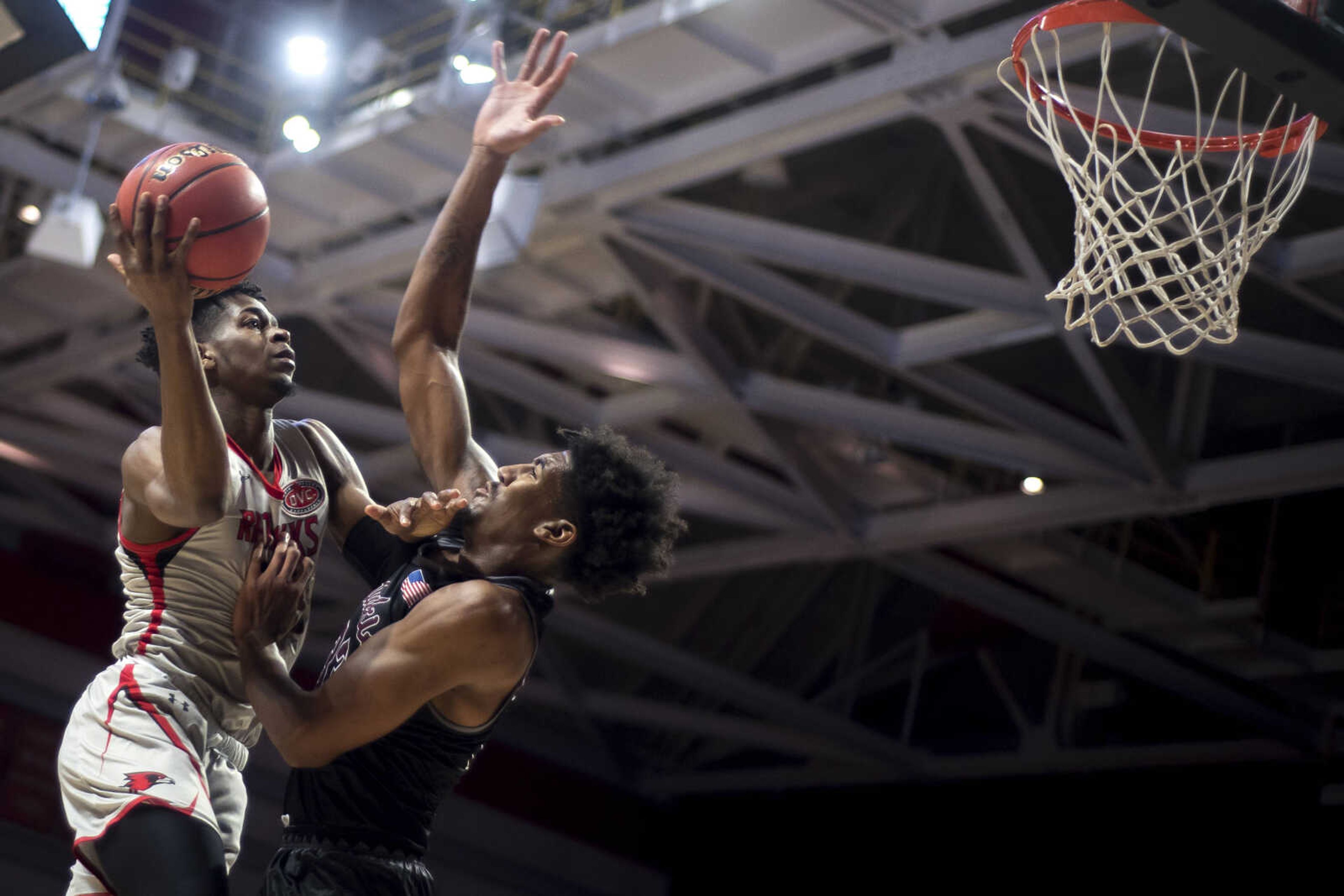 Southeast Missouri State University guard Ledarrius Brewer (25) shoots over Salukis center Kavion Pippen (33) during the Redhawks' loss to Southern Illinois University at the Show Me Center Saturday, Dec. 8, 2018.