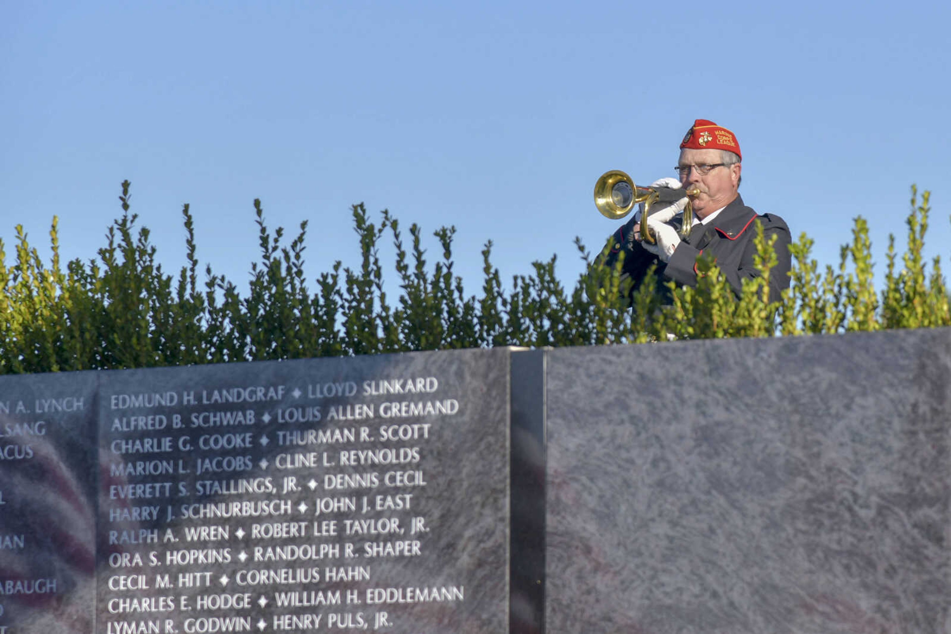 Marine Corps League Detachment 1081 David Lloyd plays "Taps" during the Veteran's Day flag presentation ceremony at Cape County Park North in Cape Girardeau on Wednesday, Nov. 11, 2020.