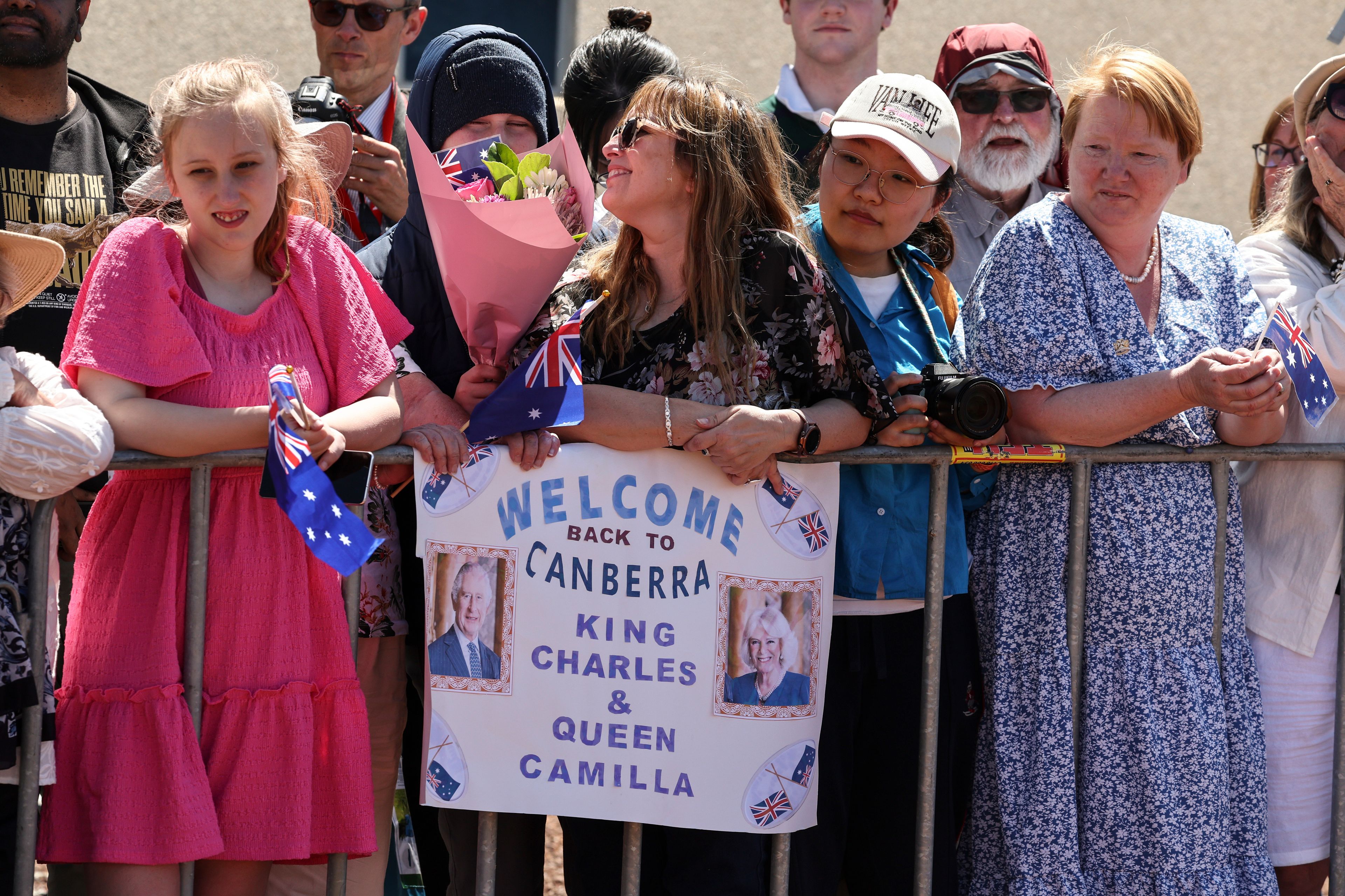 People wait to see Britain's King Charles III and Queen Camilla outside Parliament House in Canberra, Australia, Monday, Oct. 21, 2024. (David Gray/Pool Photo via AP)