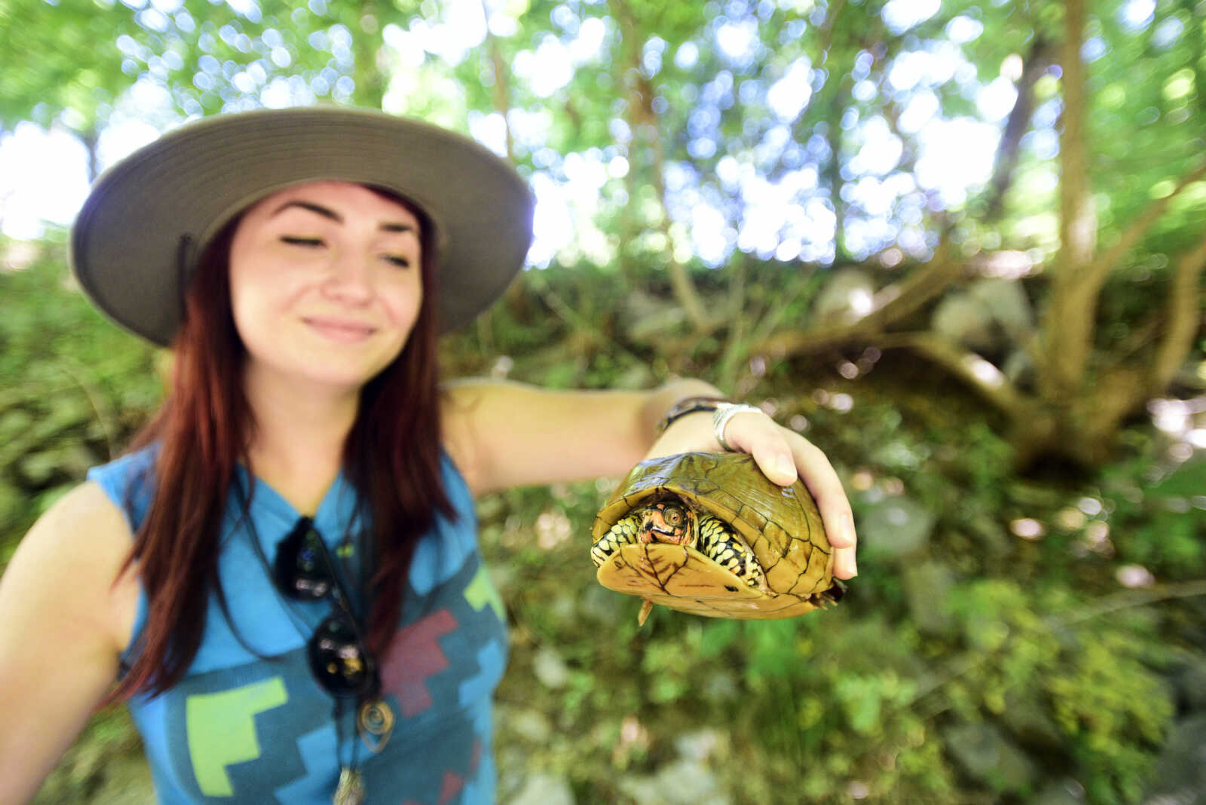 Anna Mae Zembsch holds a box turtle she found in Little Indian Creek near Oriole, Missouri.