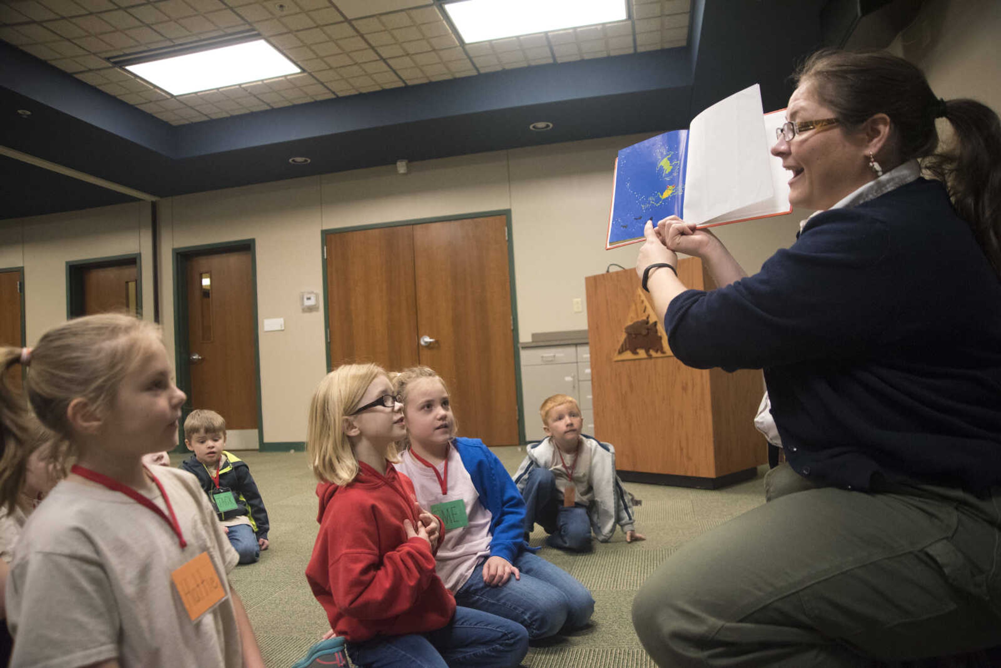 Jordi Brostoski reads the children's book "One, two, three, jump!" to students while learning about a frog's life cycle at the Cape Girardeau Conservation Nature Center Wednesday, March 29, 2017 in Cape Girardeau.