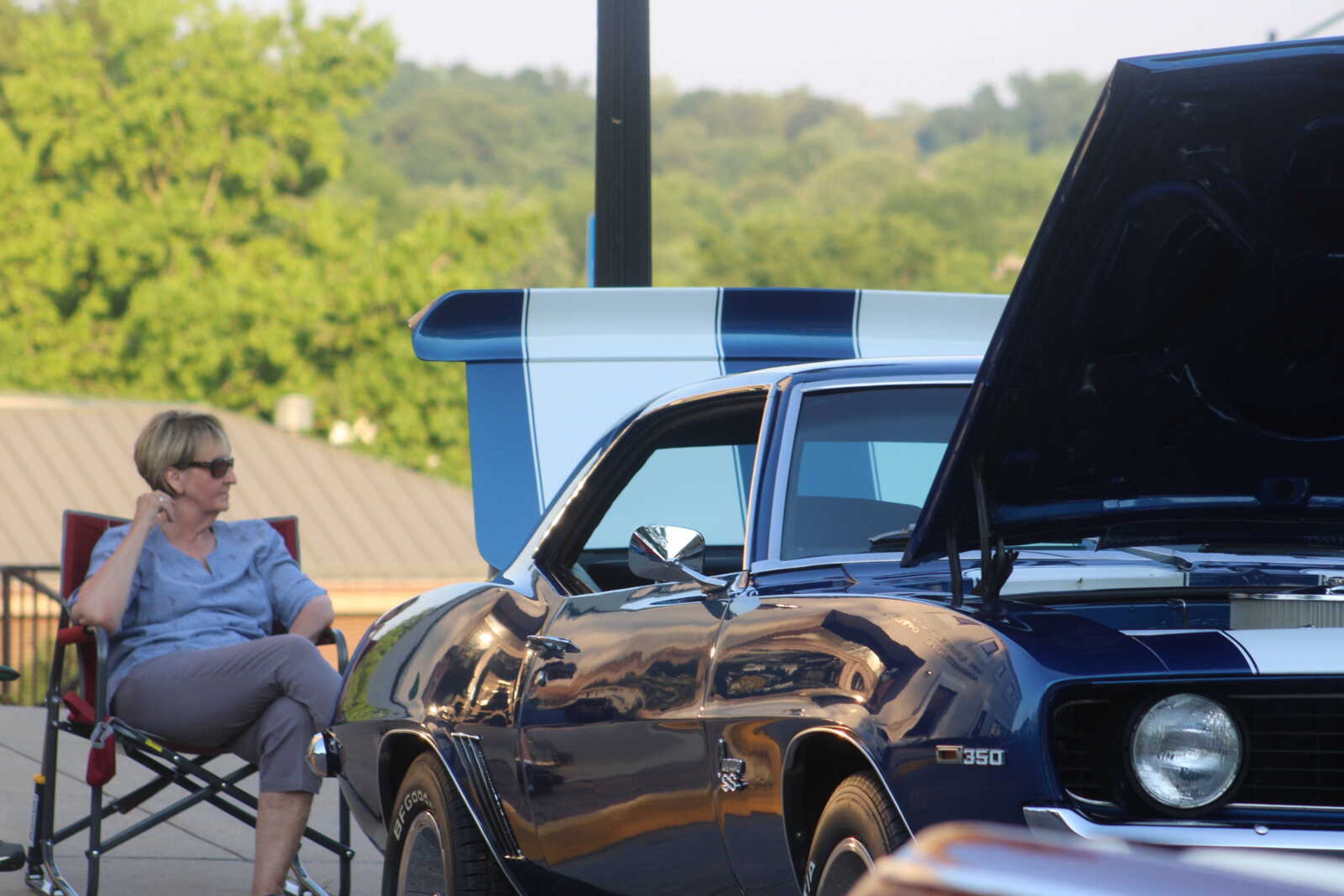 Wenona Brown sits next to her husband's 1969 Camaro during the Cruisin Uptown Car Show on Saturday, June 13, at 101 Court Street in Jackson.