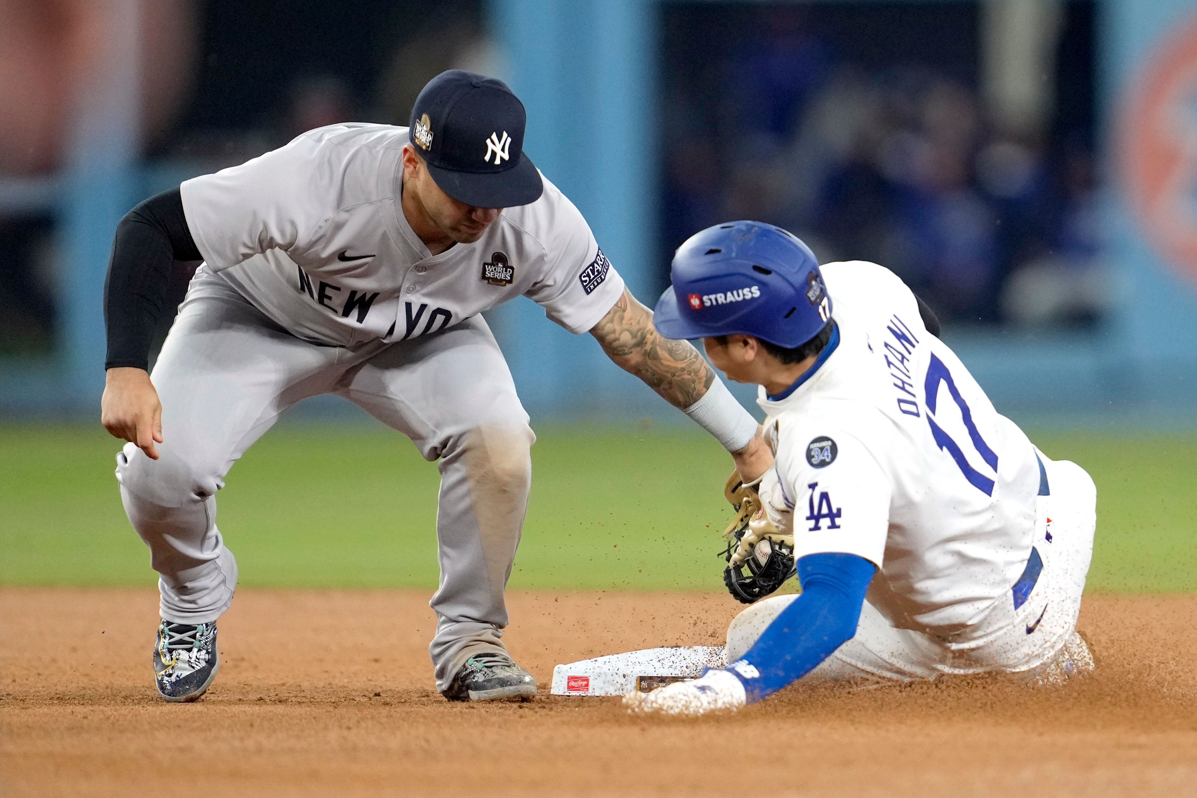 Los Angeles Dodgers' Shohei Ohtani (17) is tagged out by New York Yankees second baseman Gleyber Torres, while trying to steal second base during the seventh inning in Game 2 of the baseball World Series, Saturday, Oct. 26, 2024, in Los Angeles. (AP Photo/Godofredo A. Vásquez)