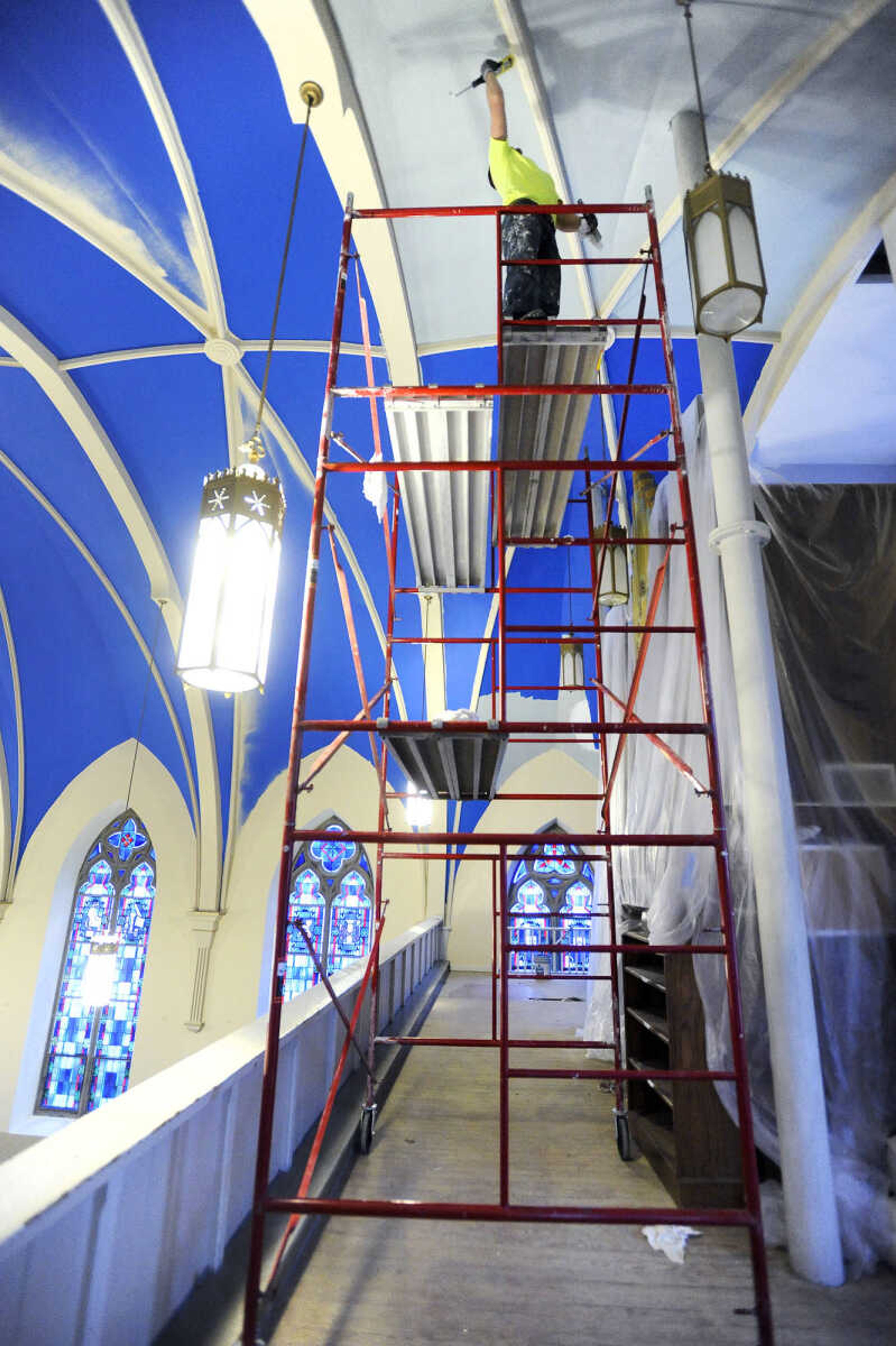 LAURA SIMON ~ lsimon@semissourian.com

Brad Earnhardt paints the ceiling surrounding the choir loft at St. John's Catholic Church in Leopold, Missouri on March 4, 2016.