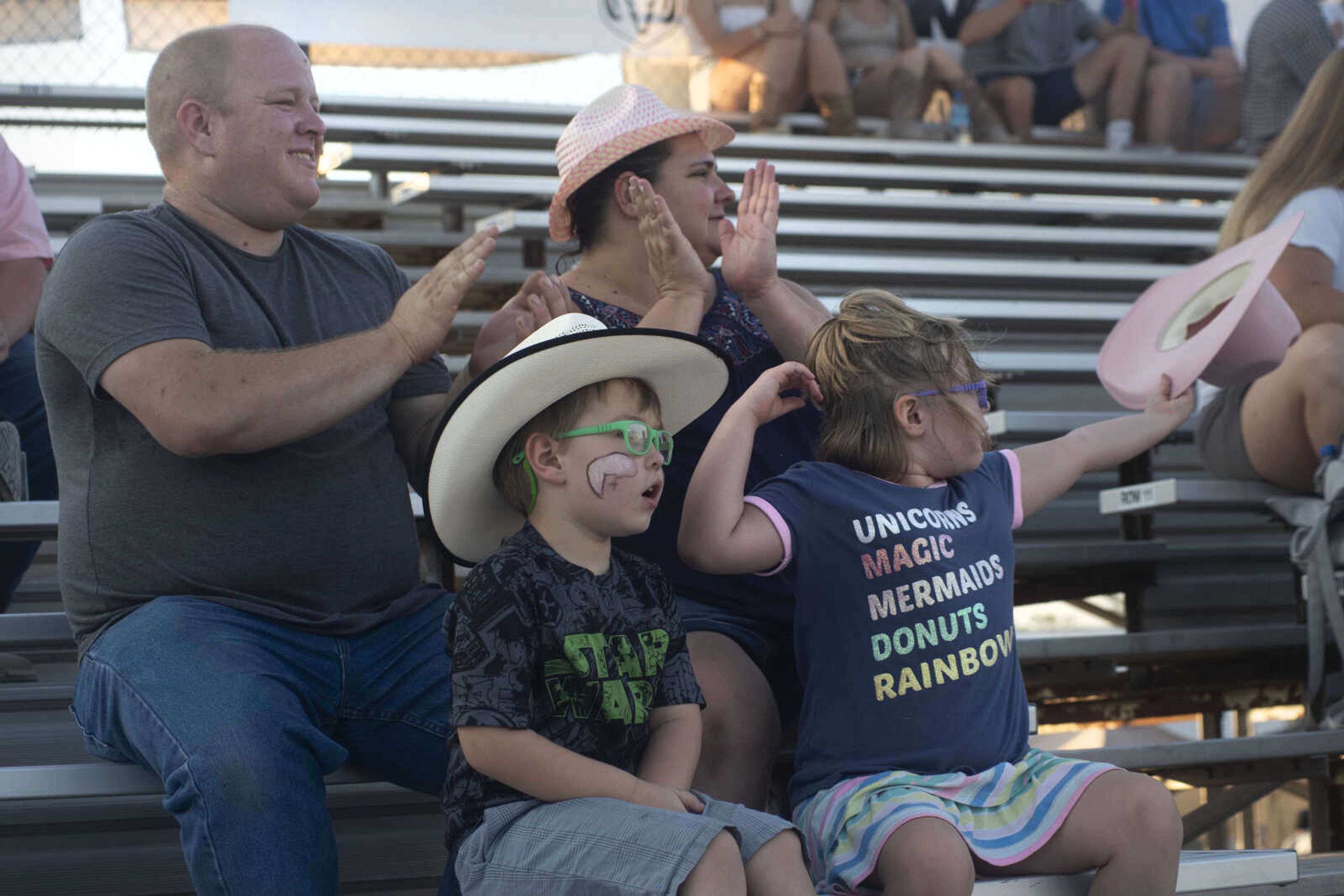 The Mansfield family, from left, Allen, Zander, Elizabeth and Katelyn, cheer during the Sikeston Jaycee Bootheel Rodeo on Thursday, Aug. 12, 2021, in Sikeston, Missouri.