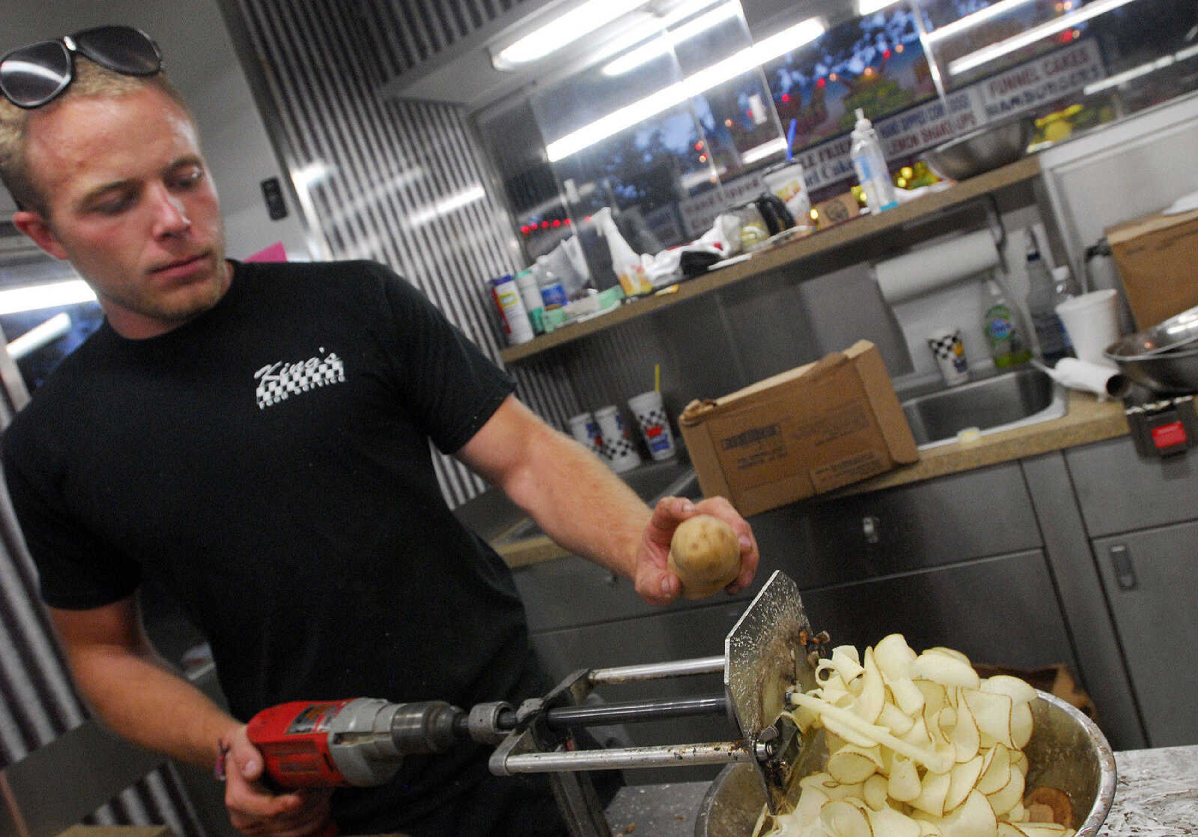 LAURA SIMON~lsimon@semissourian.com
Caleb Wilson uses a power drill to speed up the potato slicing process Thursday, September 16, 2010 during the 155th Annual SEMO District Fair.