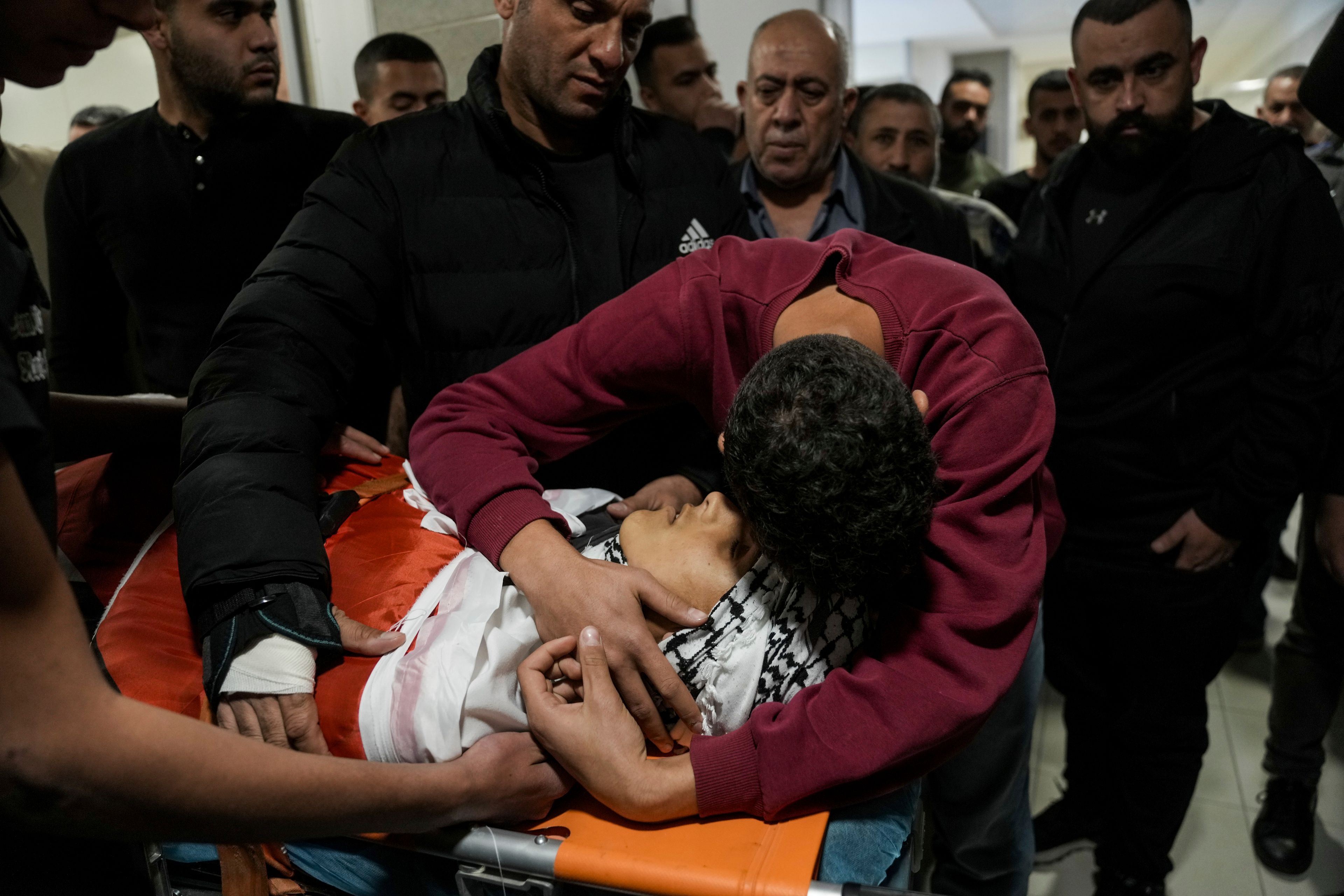 Palestinians mourn over the body of Naji al-Baba,16, who the Palestinian Health Ministry said was killed by Israeli forces in the town of Halhul, West Bank, during his funeral on Monday, Nov. 4, 2024. (AP Photo/Mahmoud Illean)