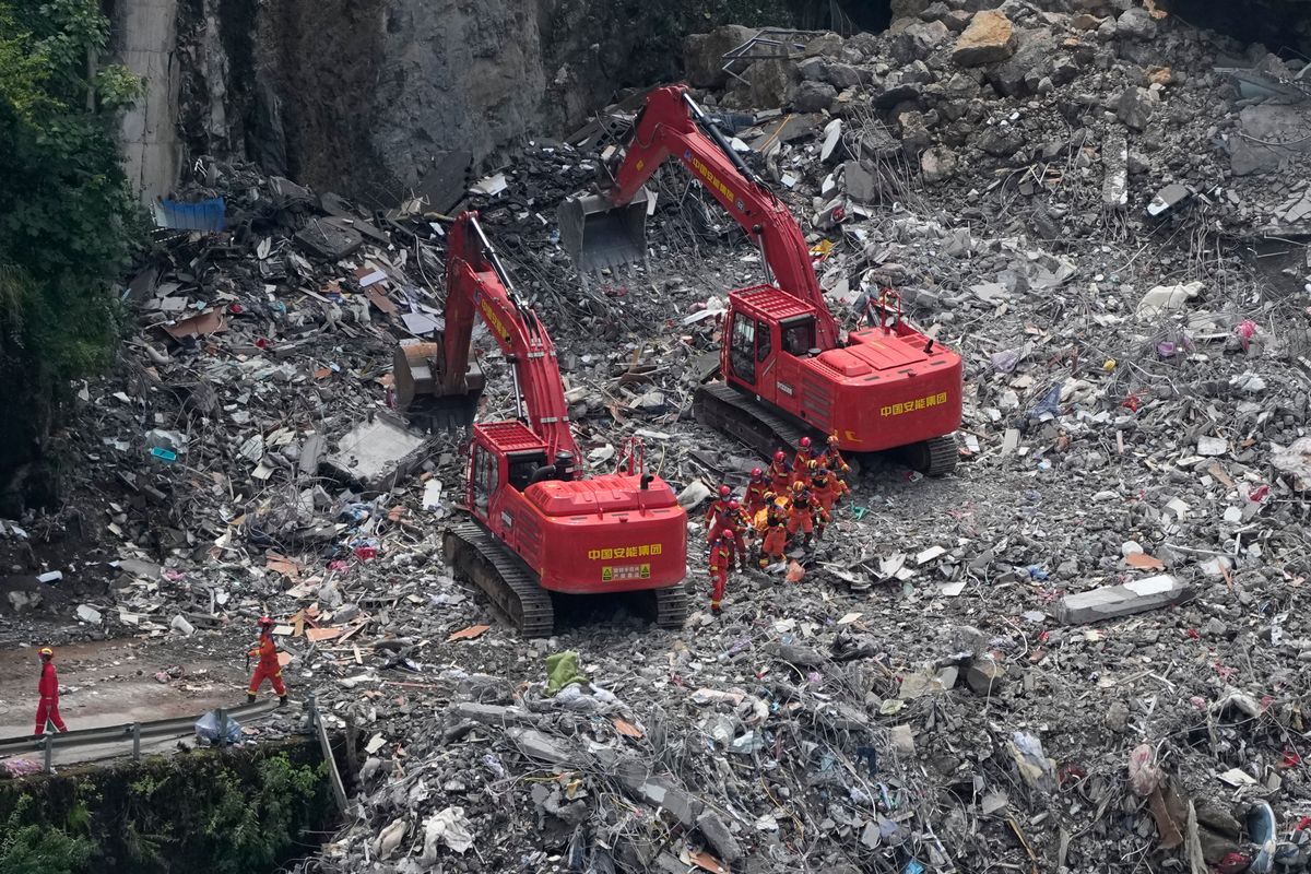 Rescuers in China search the rubble for survivors of landsli...