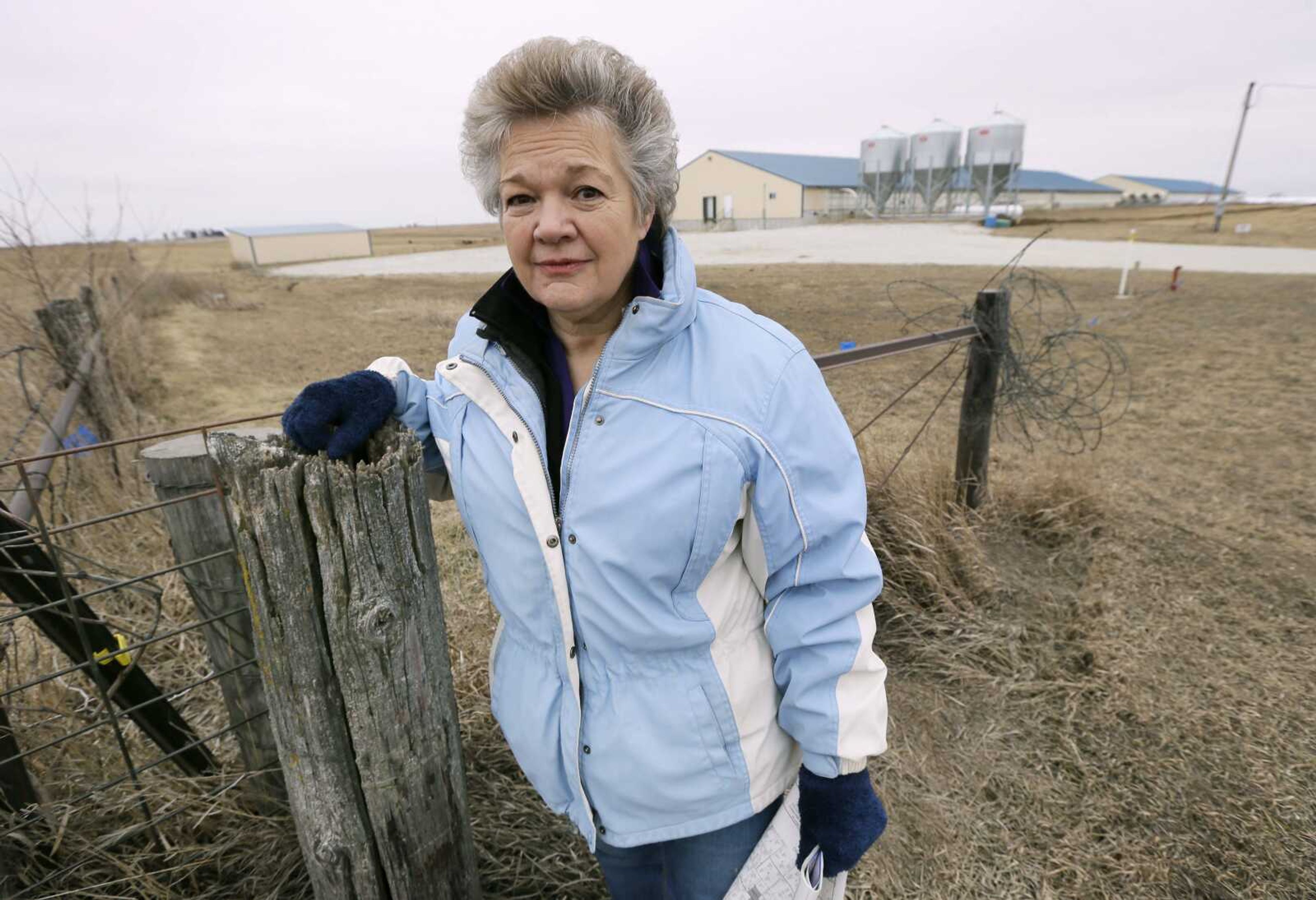 Barb Kalbach stands near a hog confinement facility Jan. 22 near Orient, Iowa. Kalbach has fought for more than a decade against the construction of huge hog operations. (Charlie Neibergall ~ Associated Press)