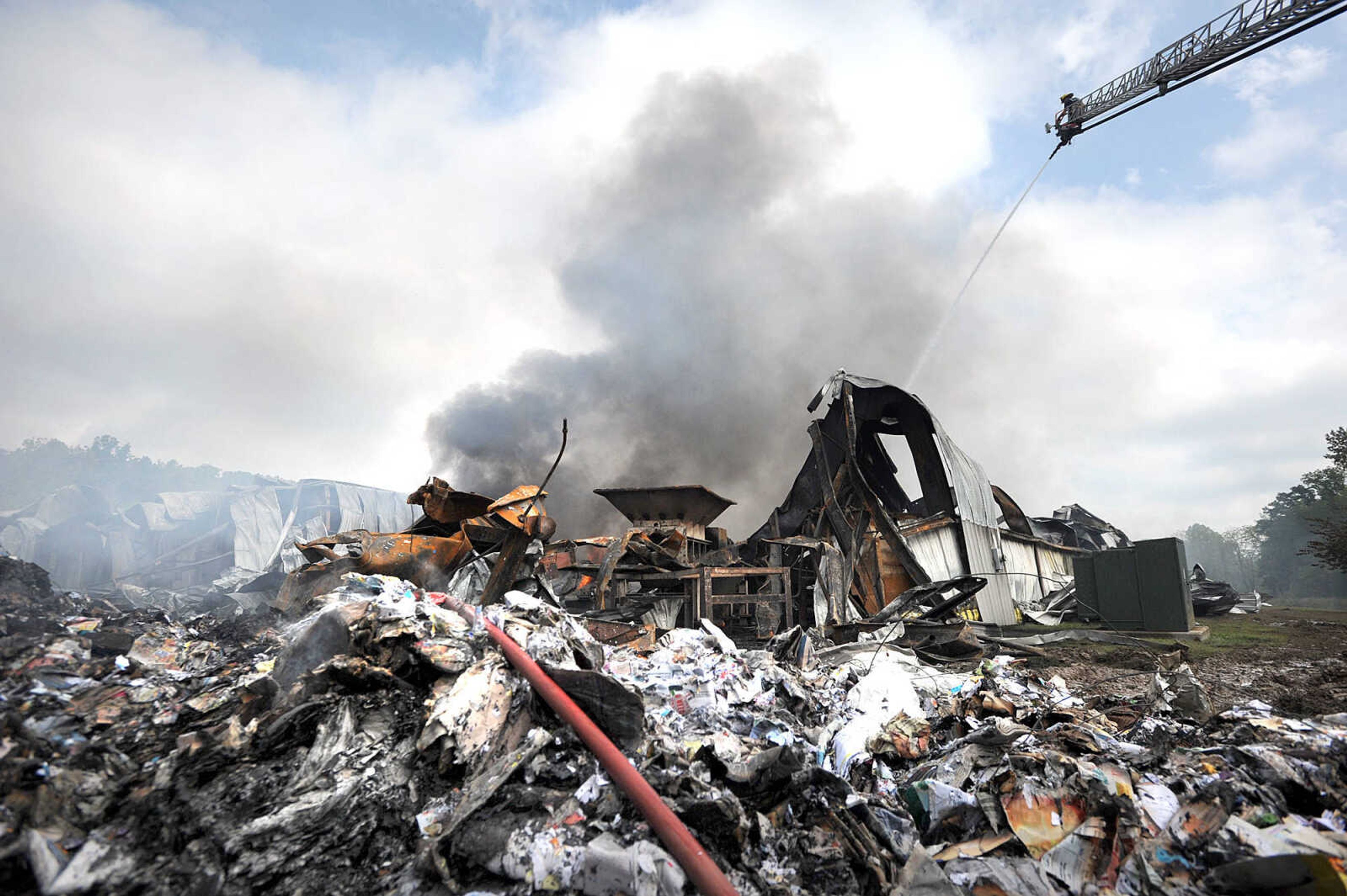 LAURA SIMON ~ lsimon@semissourian.com

Jamie Hann with the Cape Girardeau Fire Department showers the smoldering remnants of the Missouri Plastics plant Friday morning, Oct. 4, 2013, in Jackson. The approximately 100,00-square-foot recycling plant caught fire around 10 p.m. Thursday. Every fire department in Cape Girardeau County was dispatched to battle the blaze.