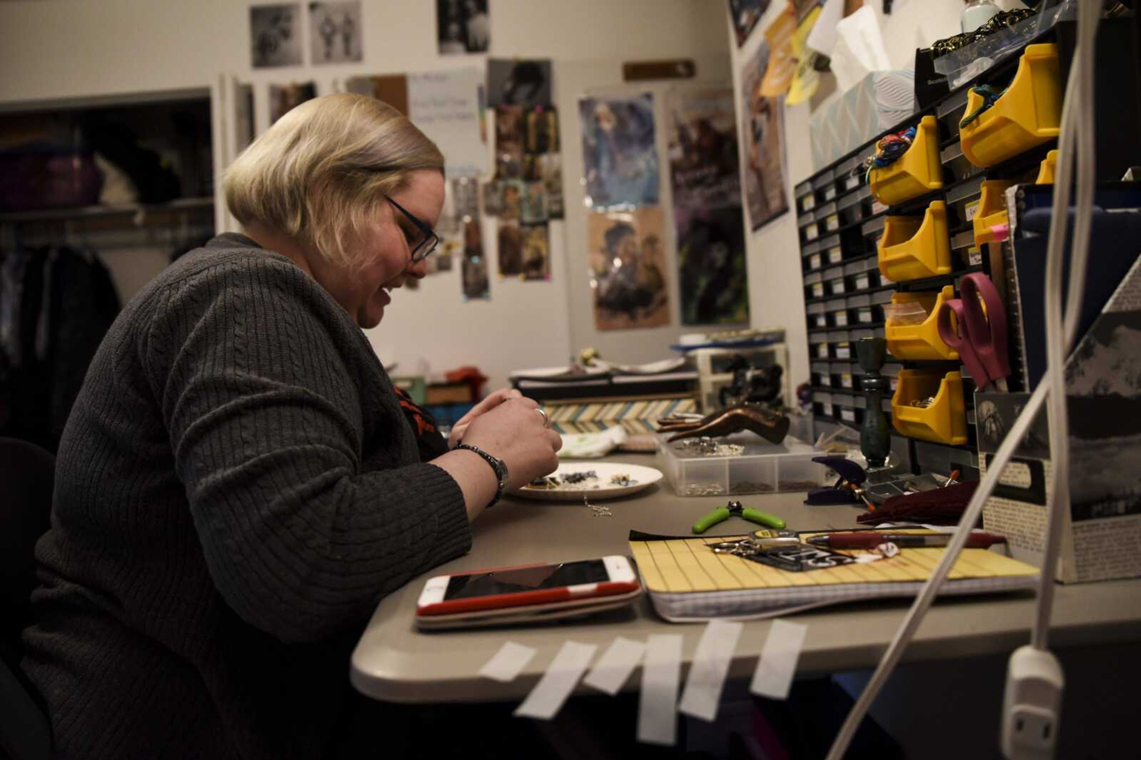 Brittany Colbert makes steampunk-themed necklaces in her Jackson home March 29.