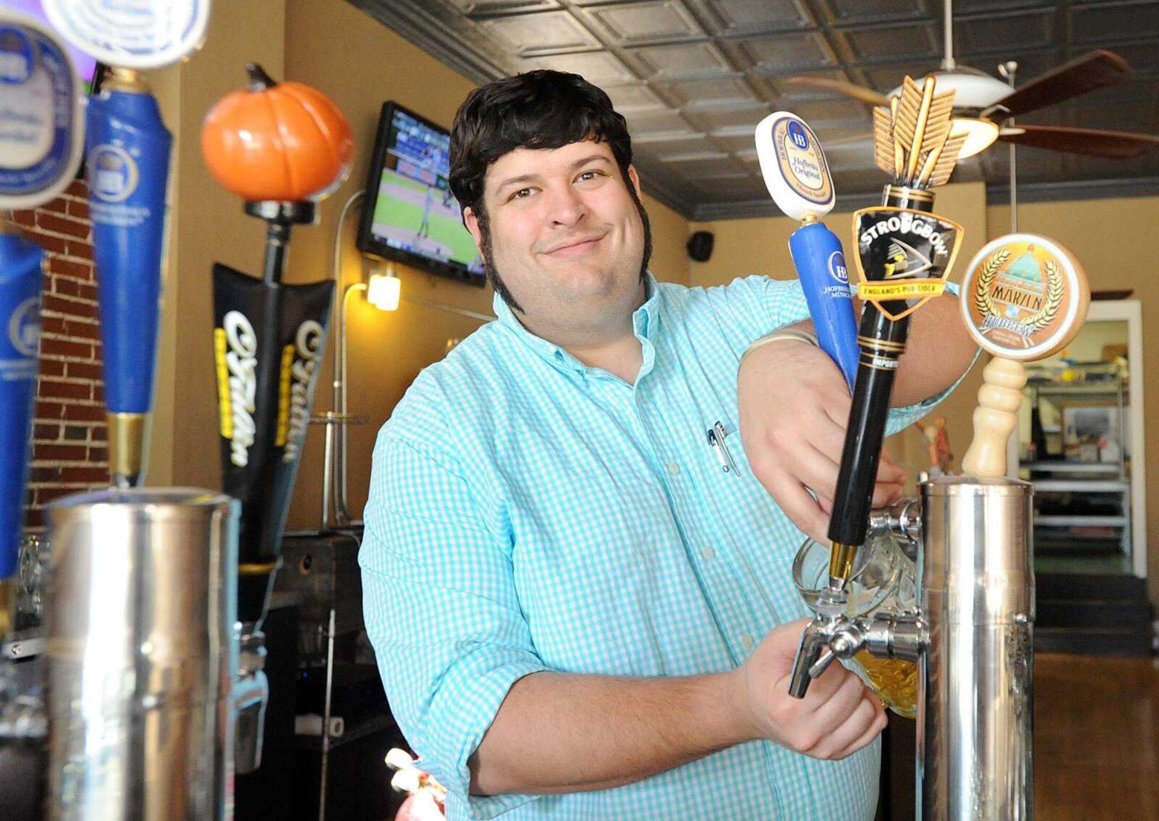 Rob Foeste, owner of Broadway Biergarten in Cape Girardeau, draws a glass of craft beer. (Laura Simon)