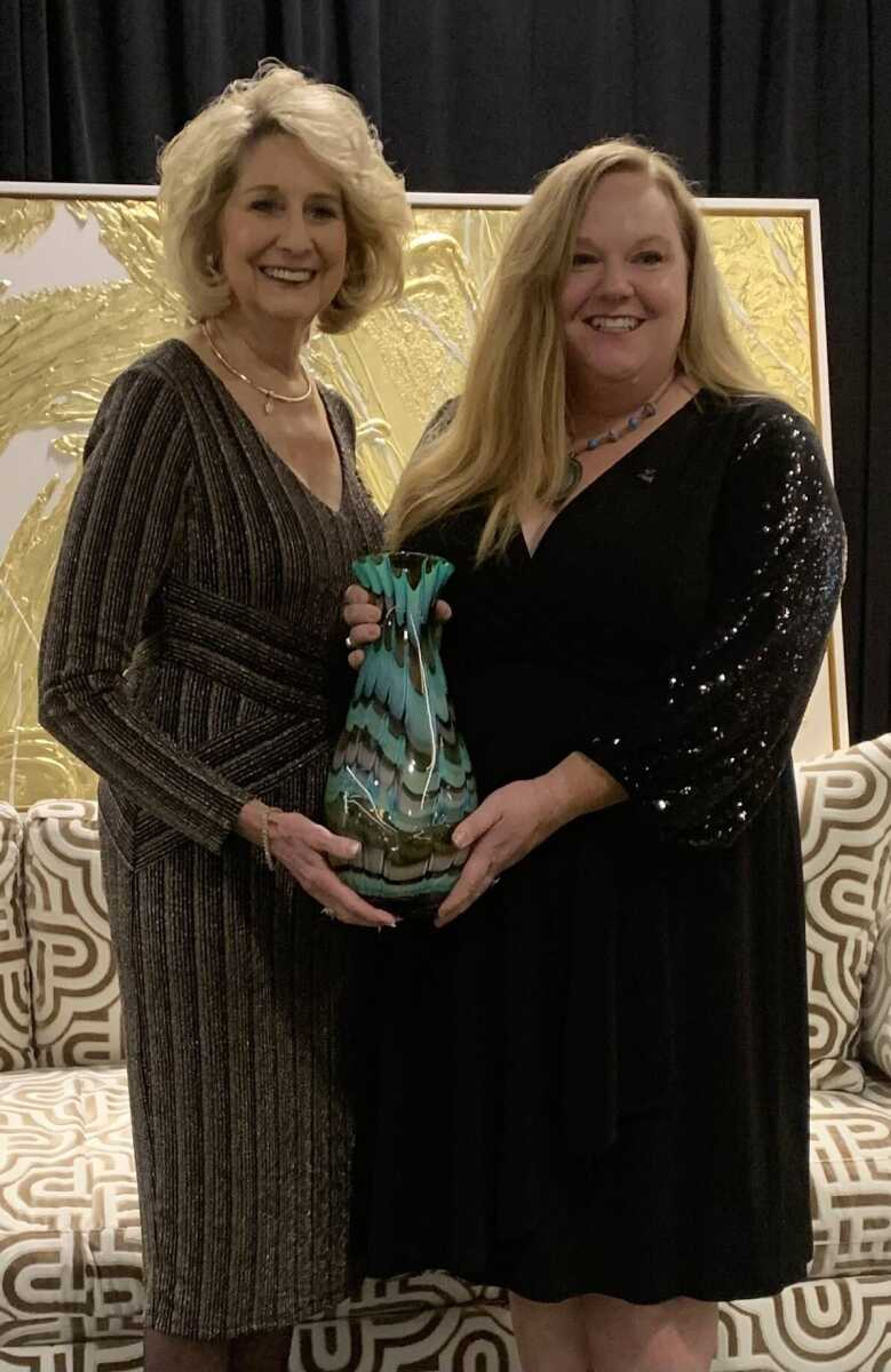 Kathryn Swan, left, is presented a Lifetime Achievement award by Amanda Lincoln during the Zonta Women of Achievement luncheon on Friday, Nov. 17, at the Drury Plaza Hotel Conference Center in Cape Girardeau.