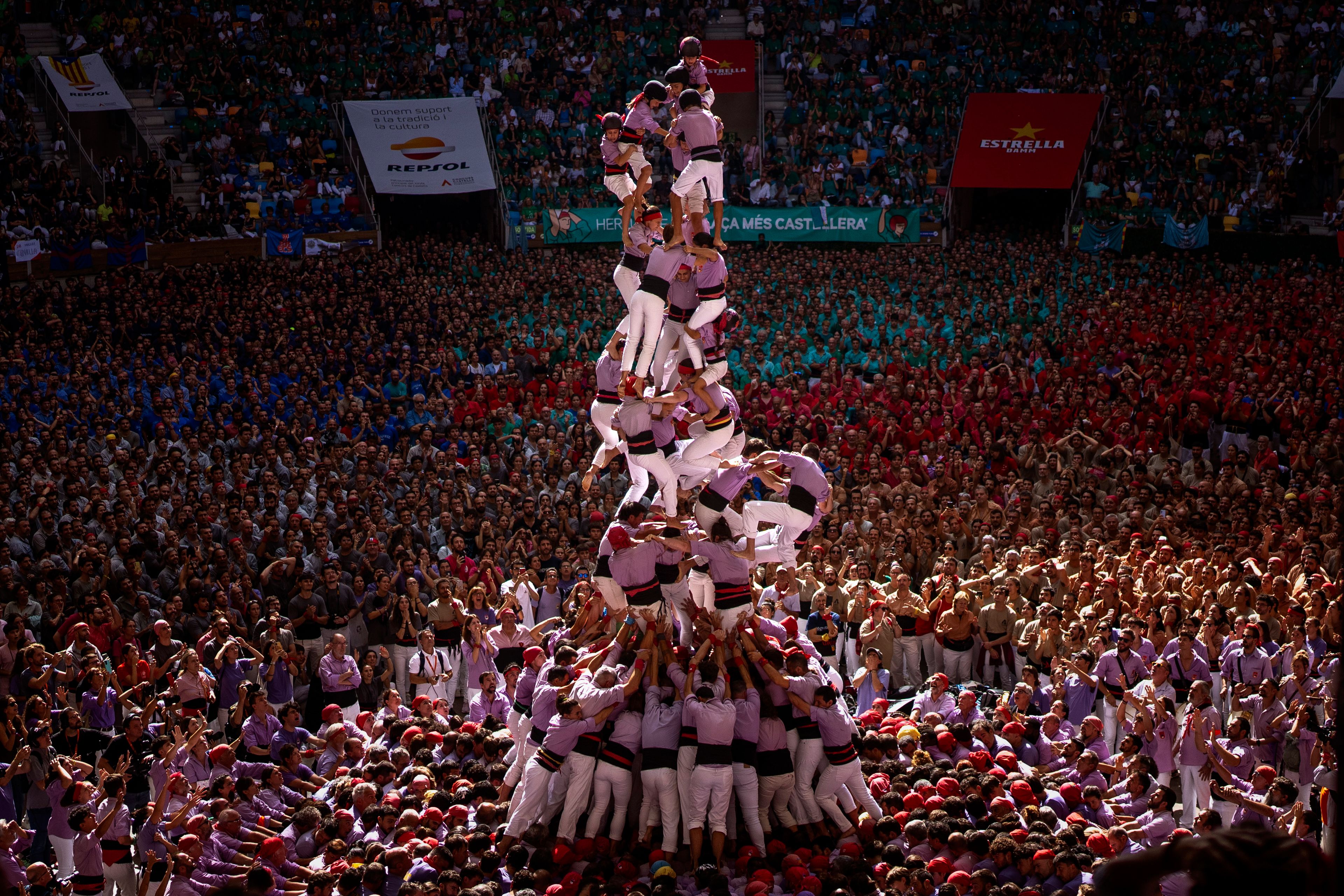 Members of "Colla Jove de Tarragona" fall before completing a "Castell" or human tower, during the 29th Human Tower Competition in Tarragona, Spain, Sunday, Oct. 6, 2024. (AP Photo/Emilio Morenatti)