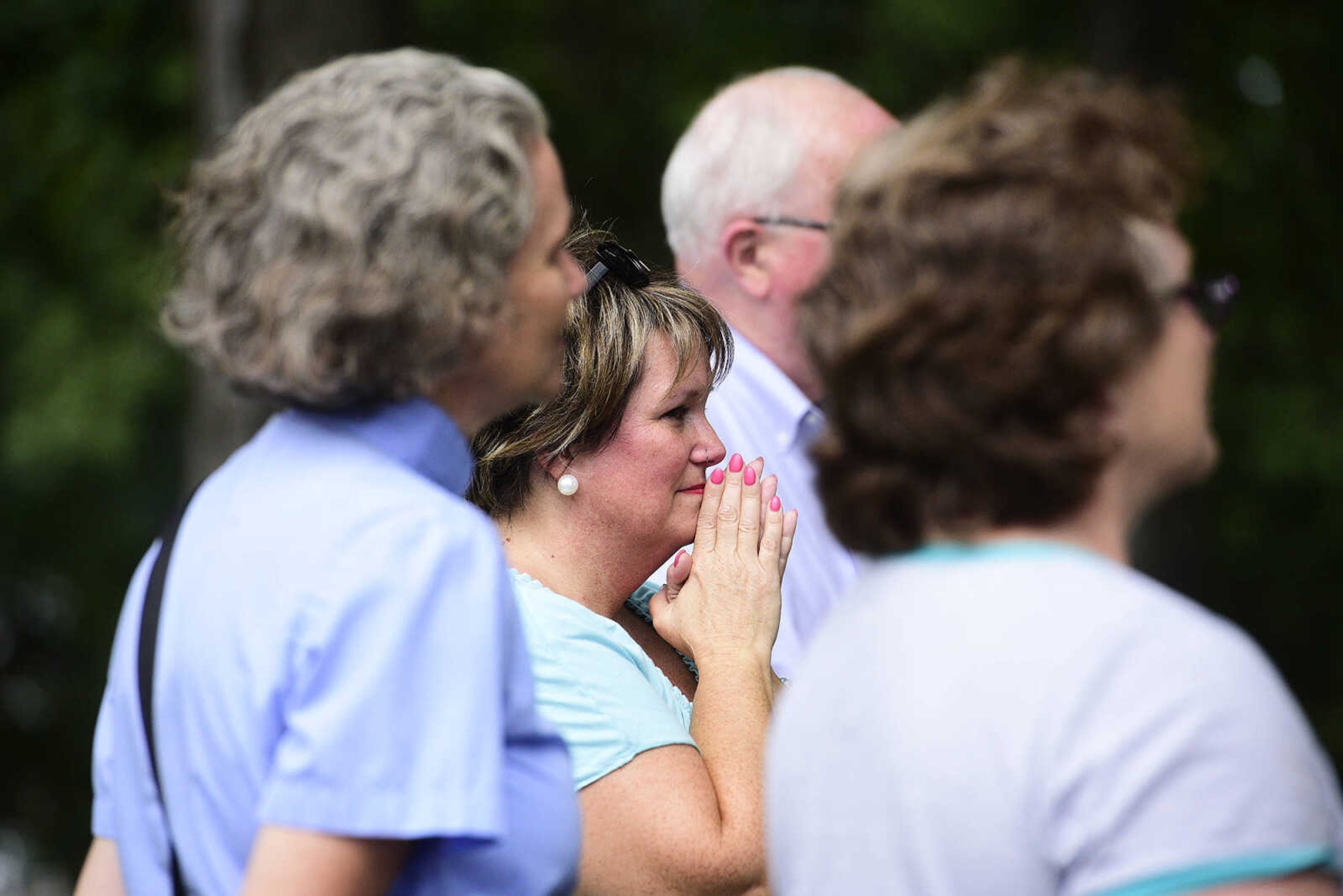 Rev. Renita Green, pastor of St. James AME, listens as Ramona Bailey sings during the Love, Not Hate rally on Sunday evening, Aug. 13, 2017, at Ivers Square in Cape Girardeau.