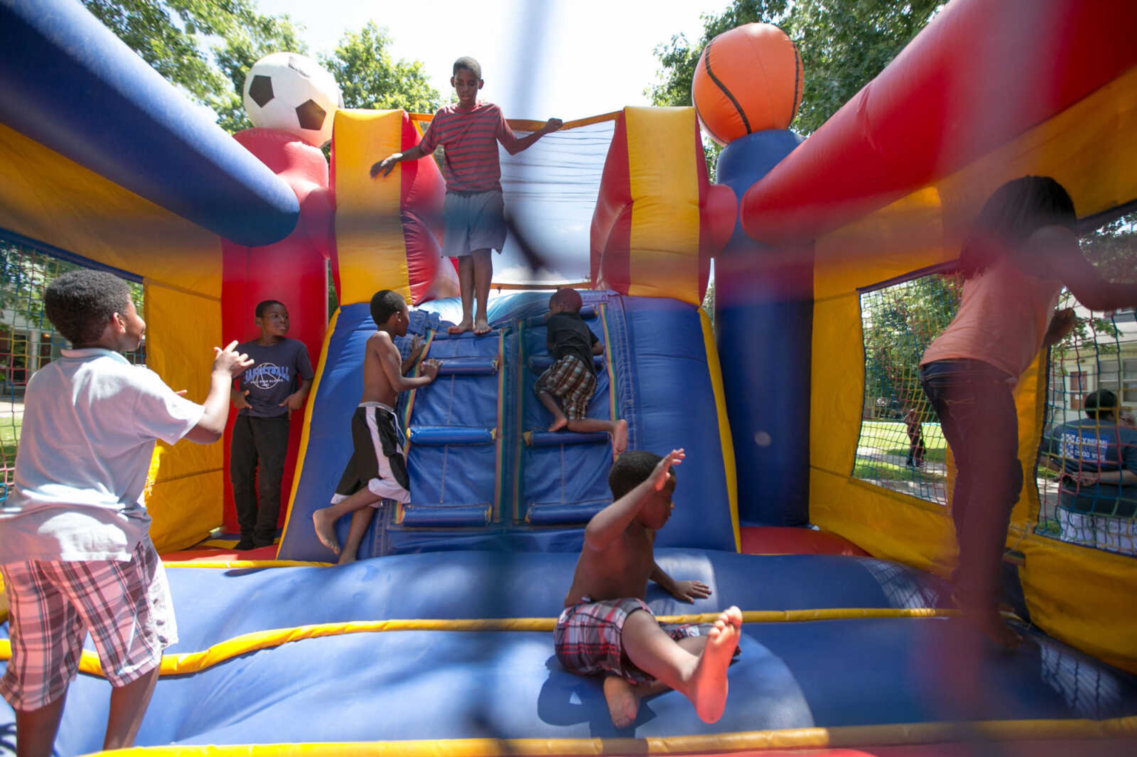 GLENN LANDBERG ~ glandberg@semissourian.com

Kids play around in a bounce house set up during the block party in Cape Girardeau's ward 2 area, Saturday, June 20, 2015.