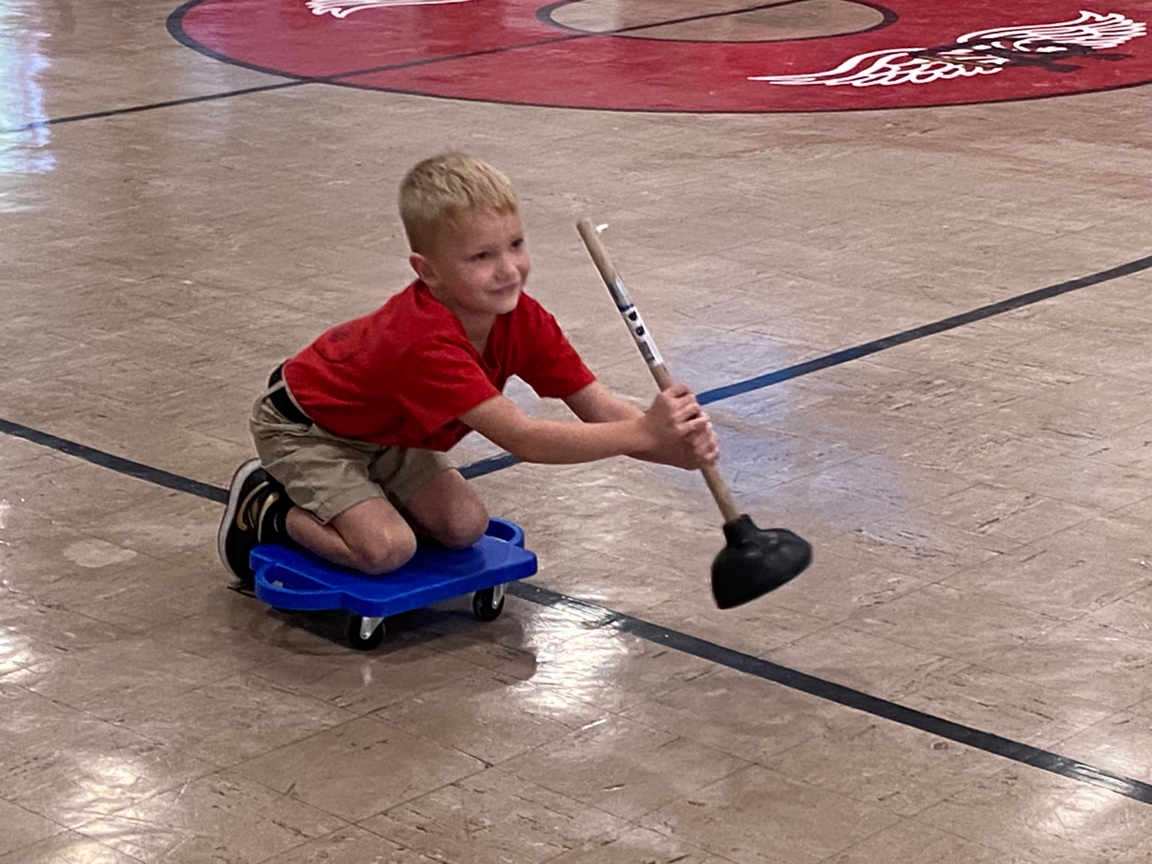 Tate Webb of St. Michael's house plunges his way across the gym floor during the "Kayaking" game.
