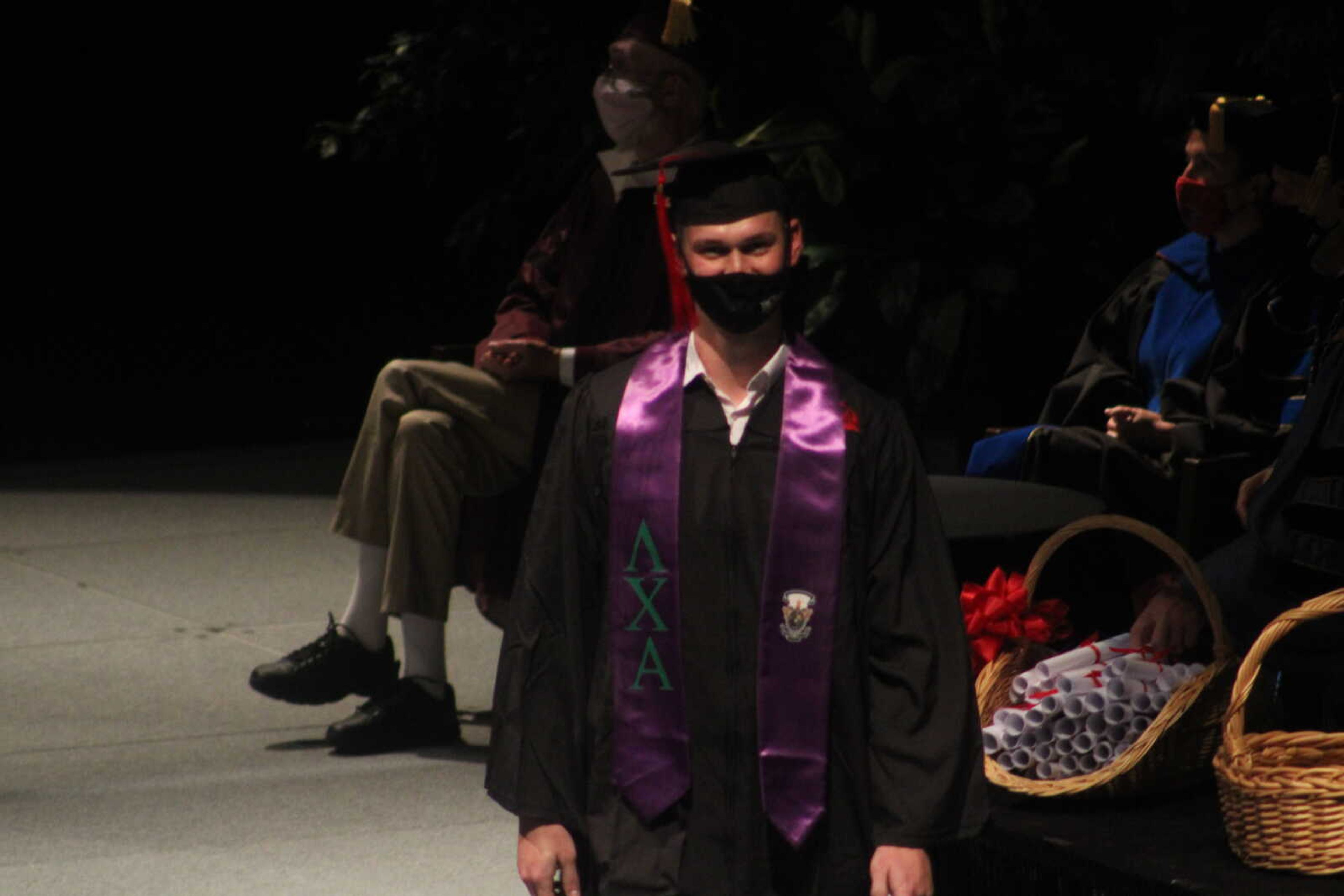 A Southeast graduate walks off the stage after receiving his diploma at the 6 p.m. spring commencement ceremony on 
Saturday, May 15, 2021, at the Show Me Center in Cape Girardeau.